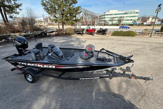 2026 Tracker Pro Team 175 boat on trailer in parking lot, sunny day.