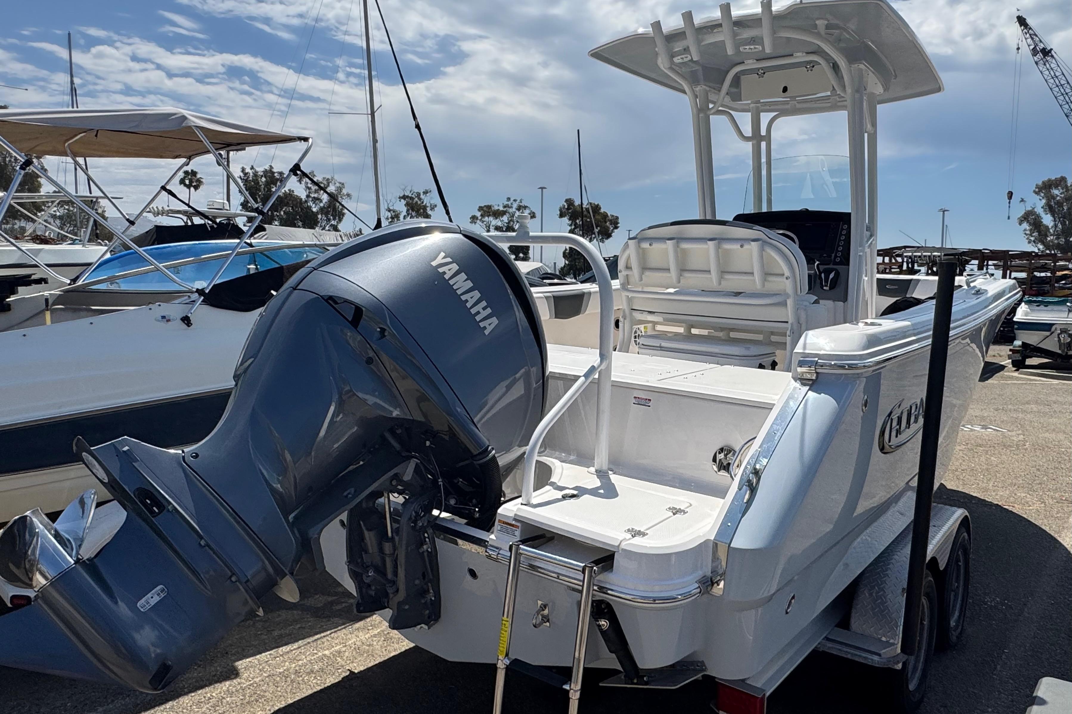 2022 Robalo R230 Center Console boat with Yamaha outboard engine, docked at marina.