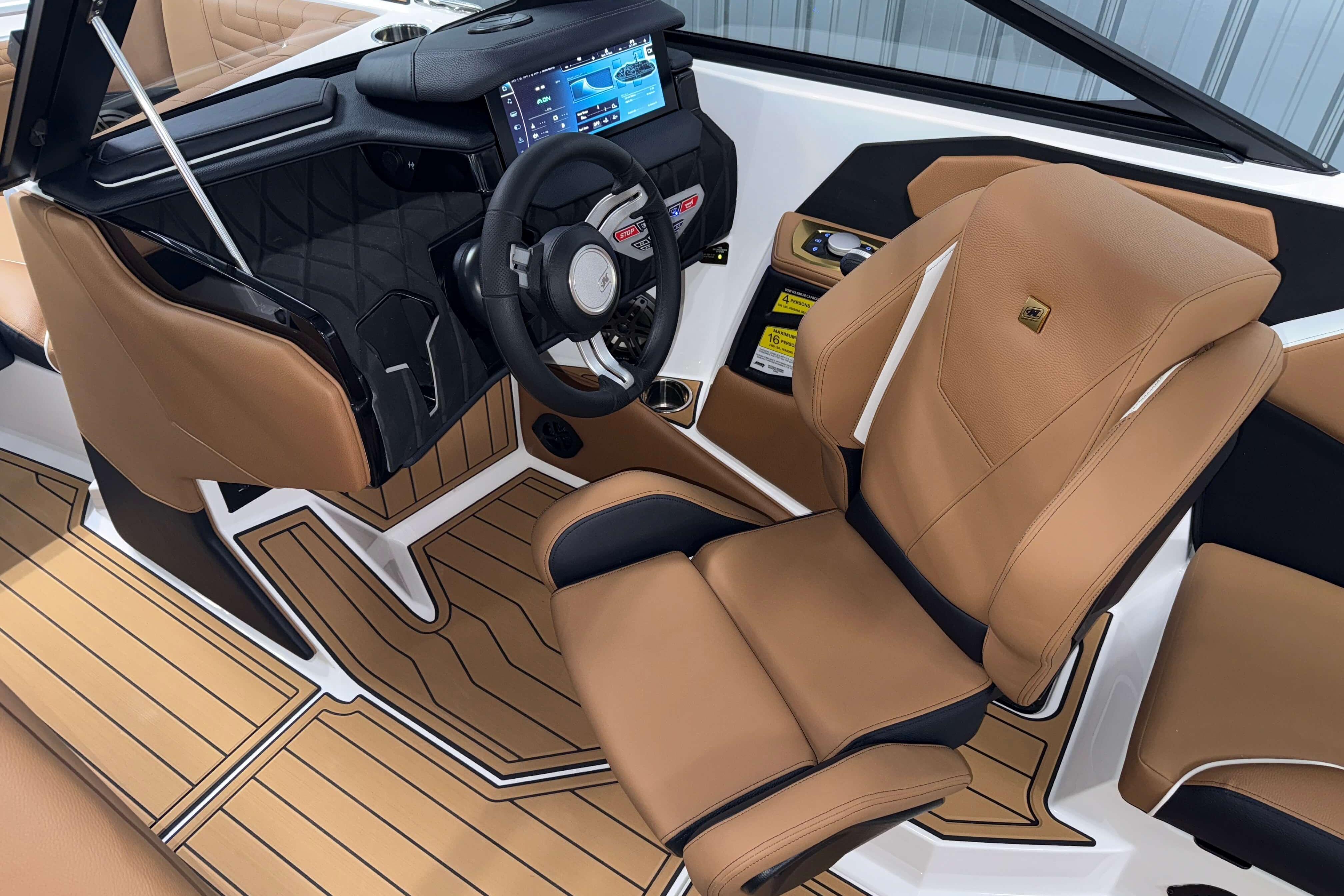 2026 Nautique Super Air Nautique S23 interior with tan seats and modern dashboard.