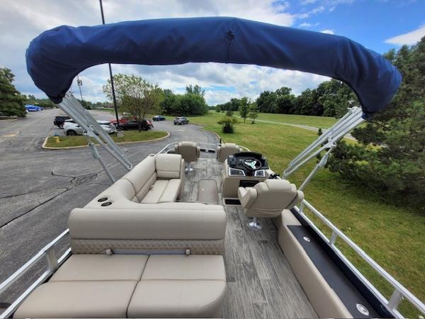 2024 Ranger Reata 223F pontoon boat with spacious seating and canopy, parked outdoors.