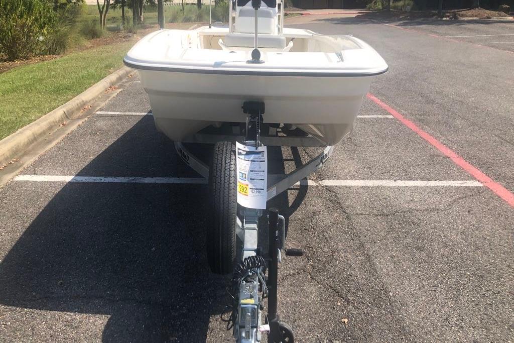 2026 Mako Pro Skiff 17 CC boat on trailer in parking lot.