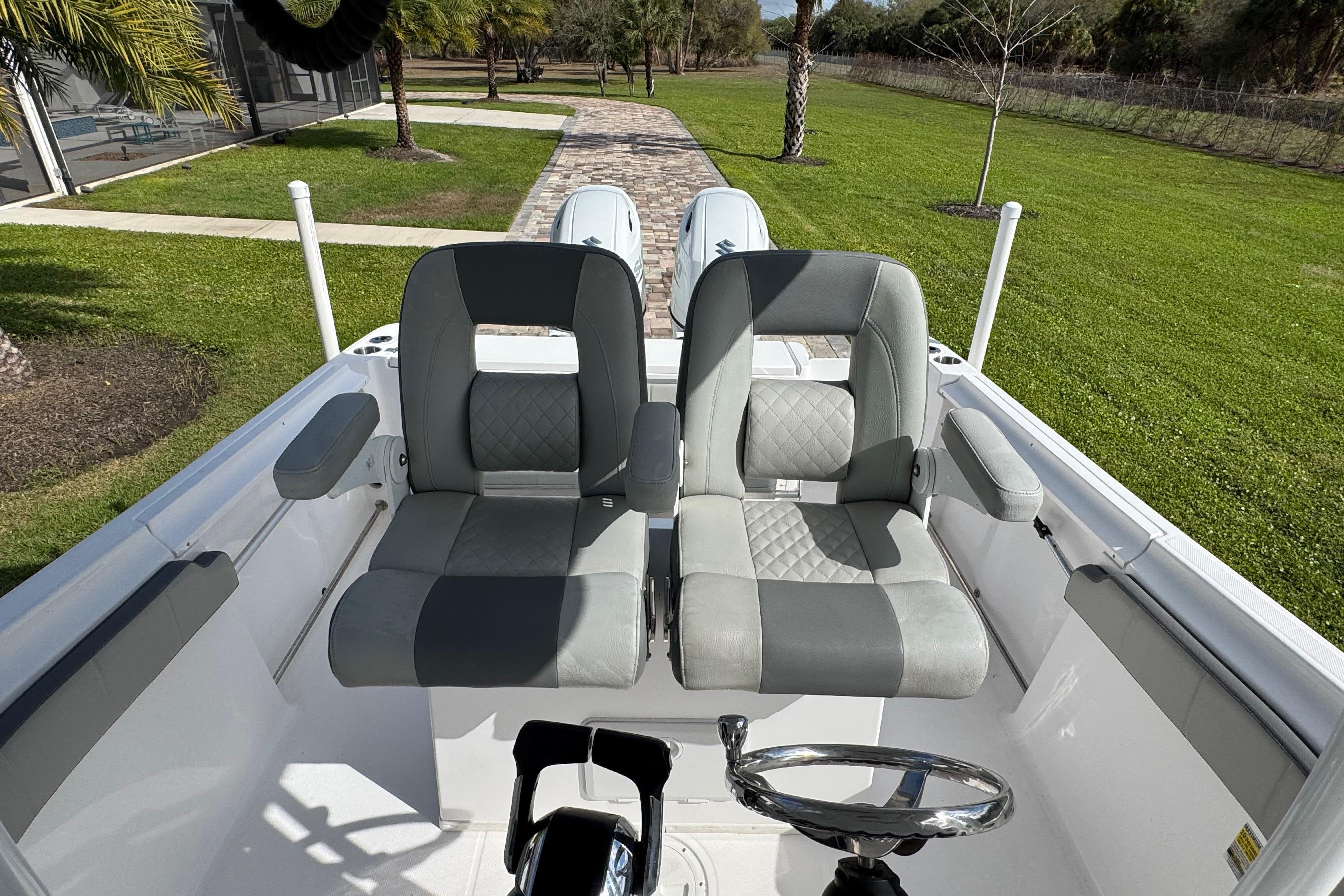 2022 Aquasport 2500 Center Console boat with dual seats and steering wheel.