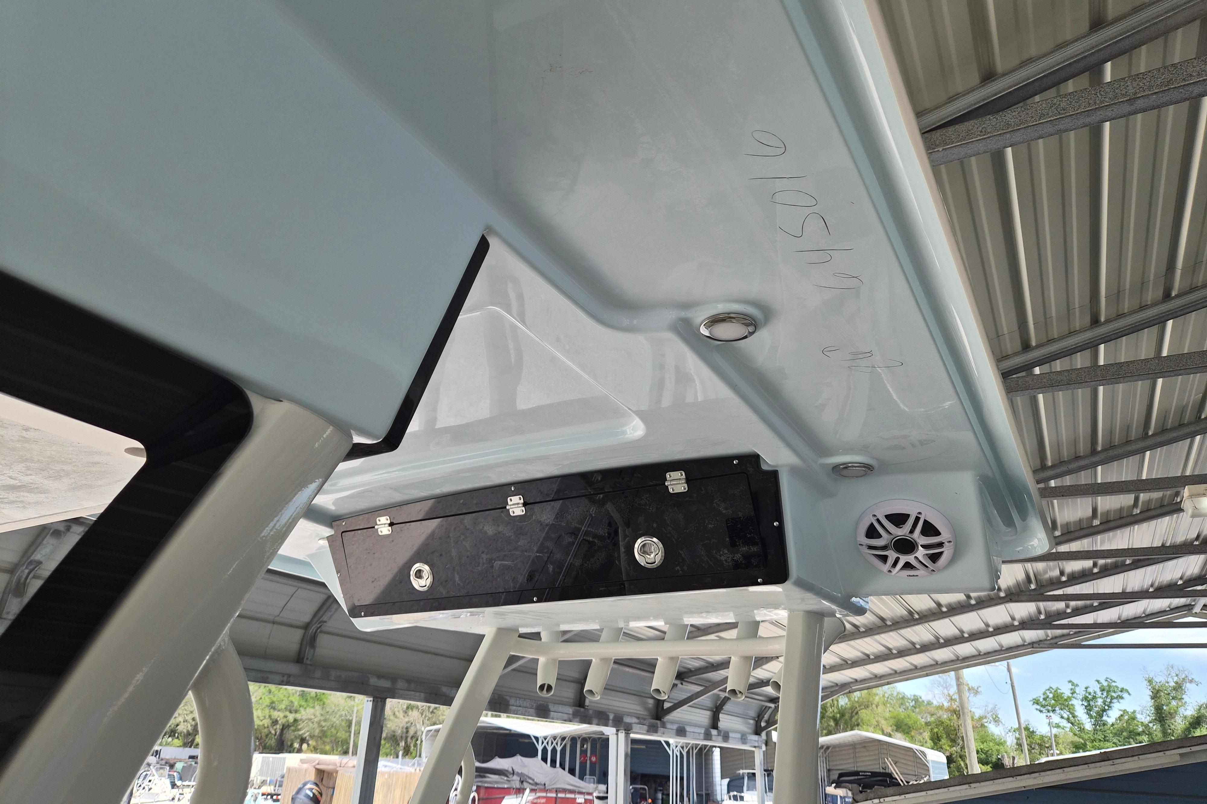 2026 Key West 260 Center Console boat under a metal canopy, featuring speakers and storage.