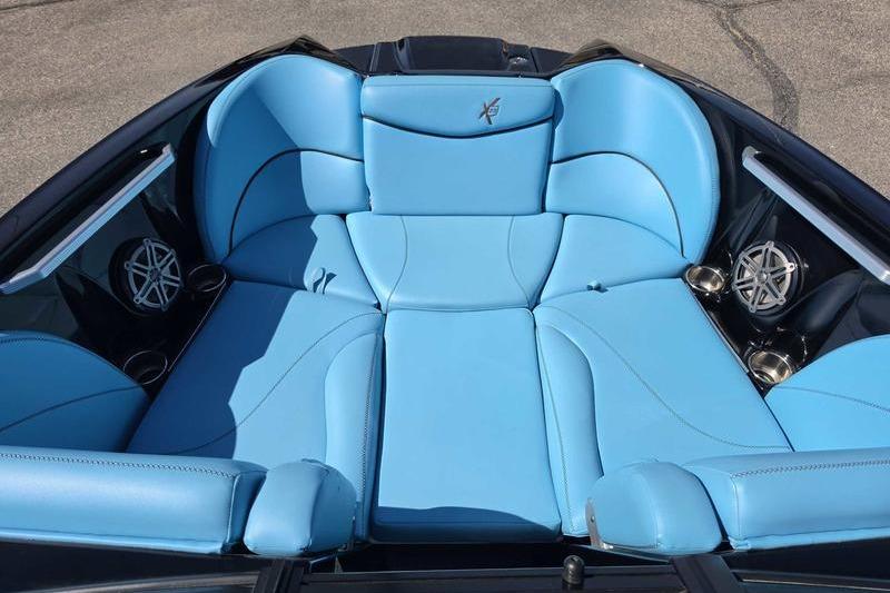 Luxurious blue seating in a 2017 MasterCraft X23 boat, featuring sleek design and premium materials.