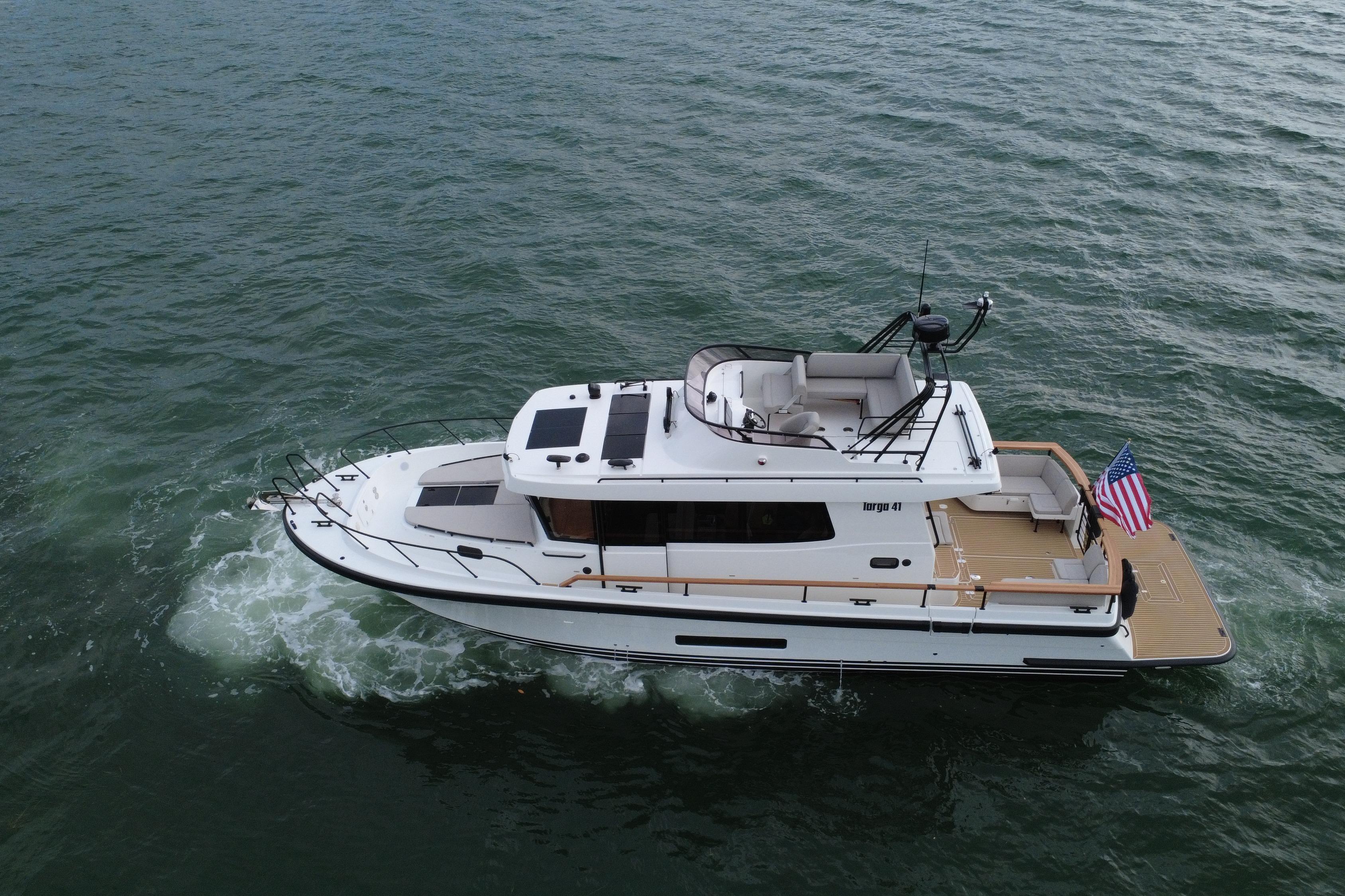 2026 Targa 41 yacht cruising on open water with American flag.