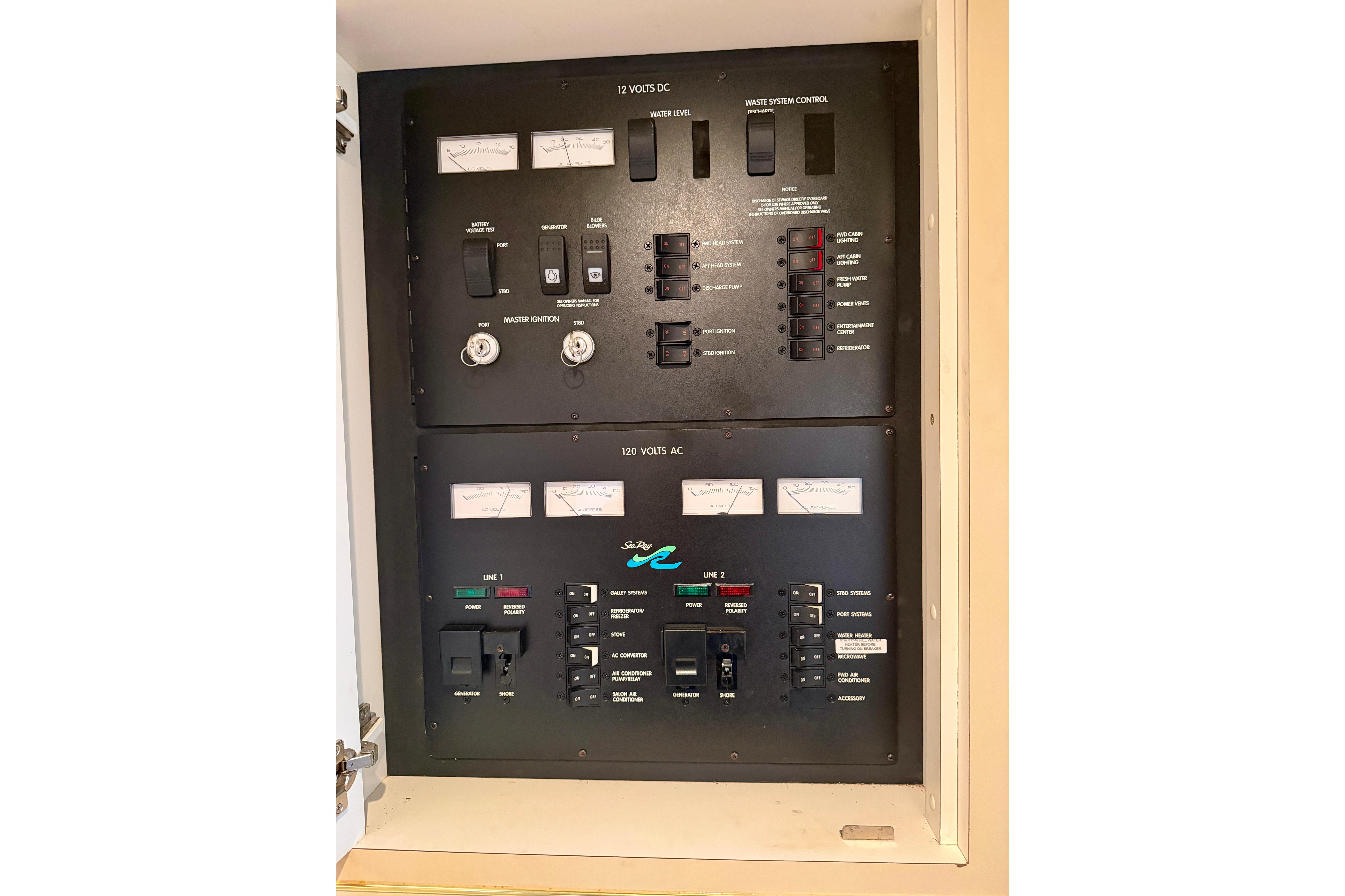 Electrical control panel of 1999 Sea Ray 400 Sundancer boat, featuring 12V DC and 120V AC systems.