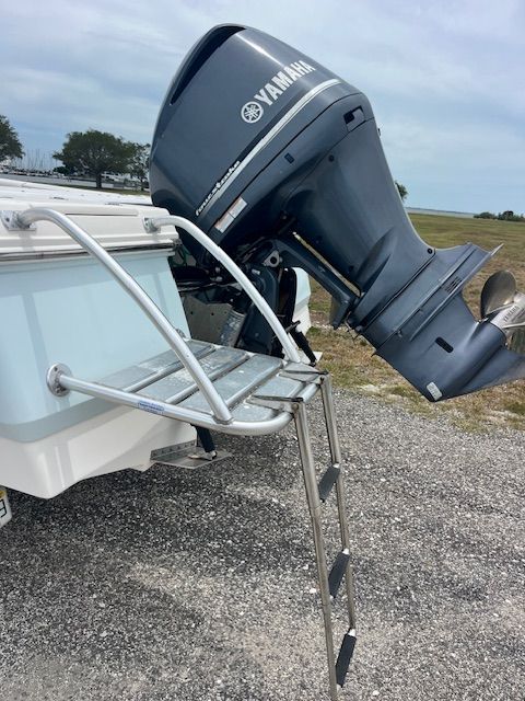 A 2015 Robalo 246 Cayman with a Yamaha engine and a swim ladder.