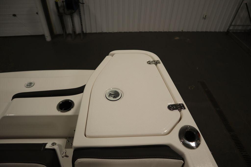 2026 Yamaha Boats 255 FSH Sport E, white deck detail with storage compartment.