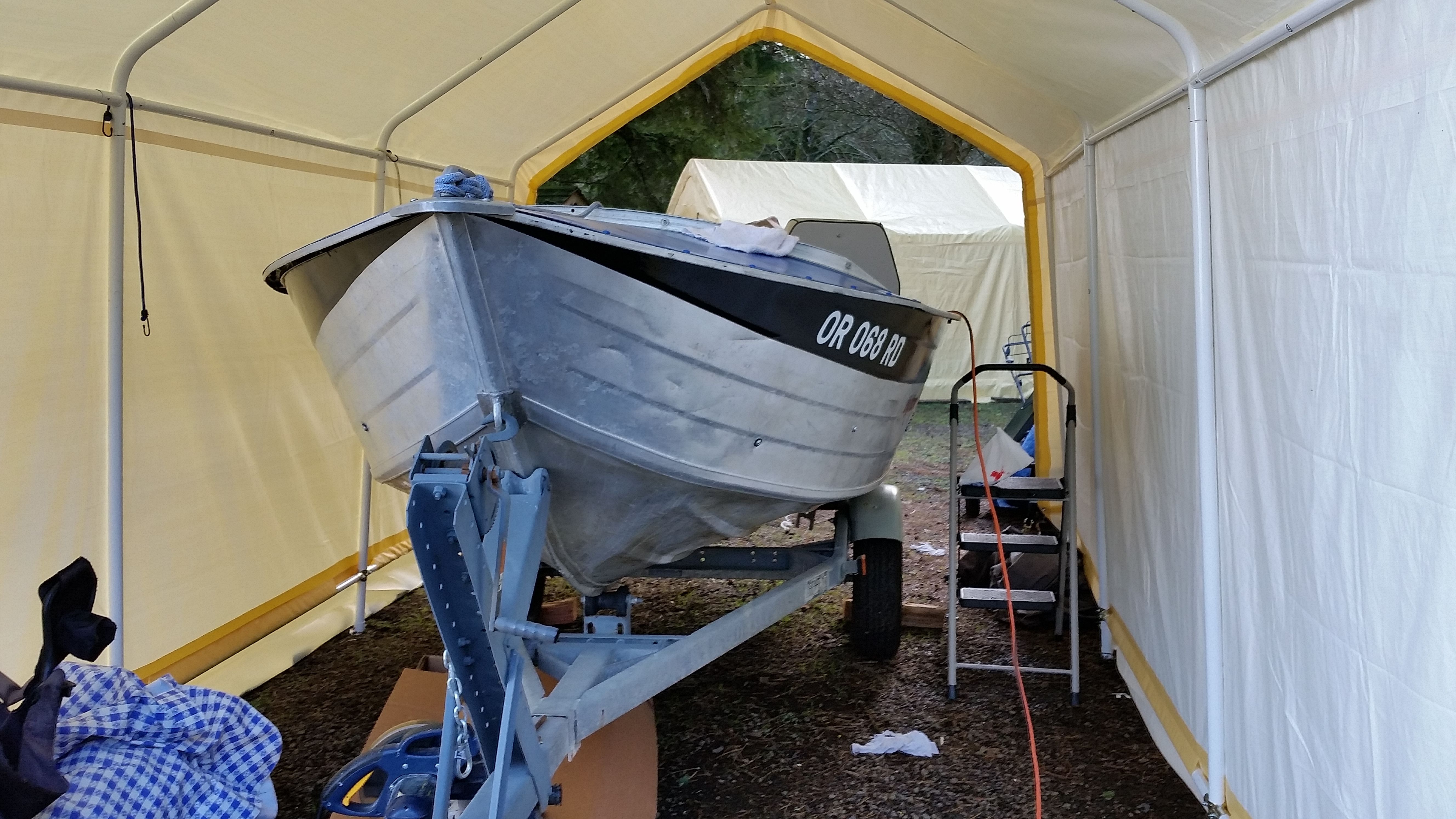 1988 Duraboat aluminum fishing boat on a trailer inside a tent.