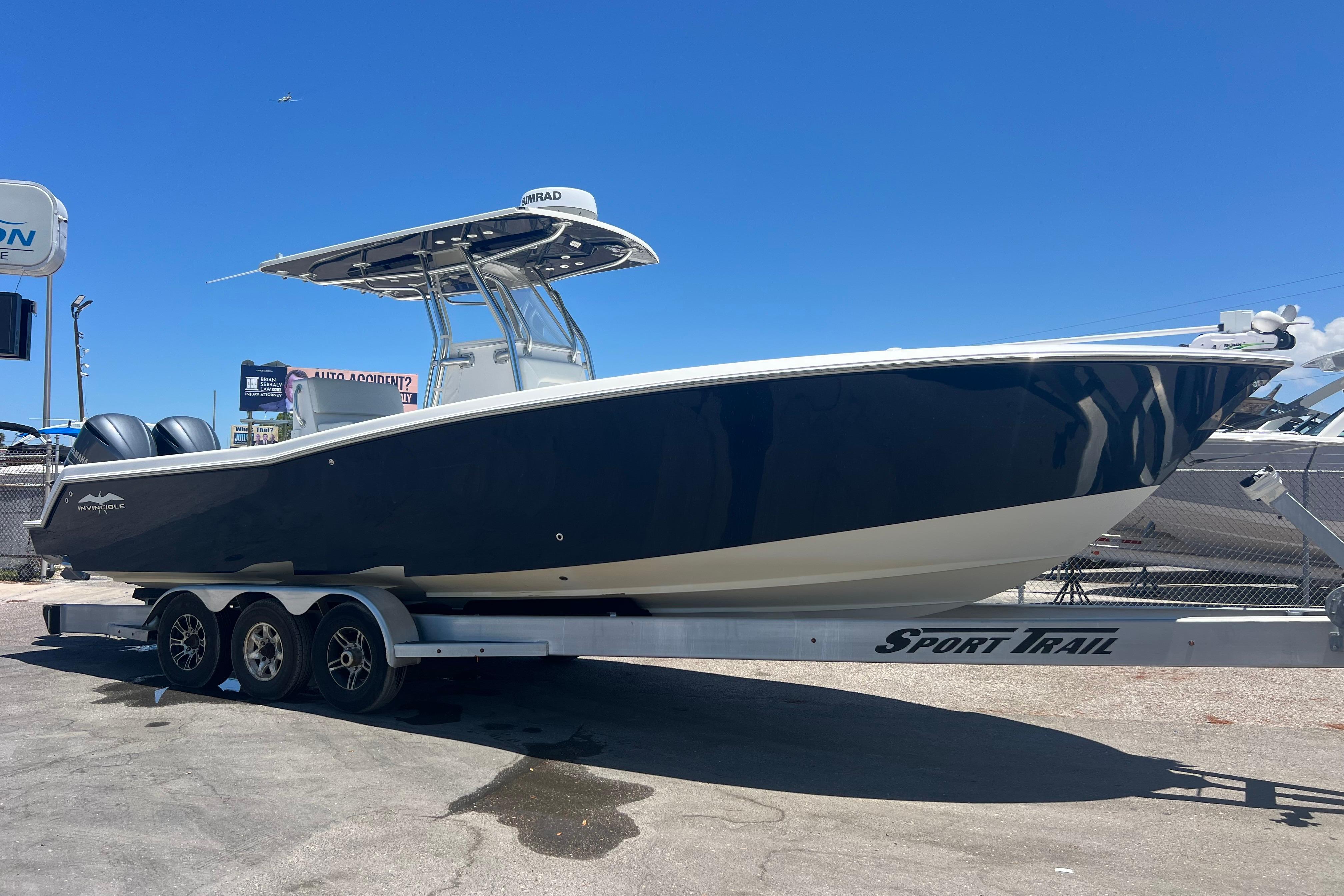 2012 Invincible 33 Open Fisherman boat on trailer under clear blue sky.