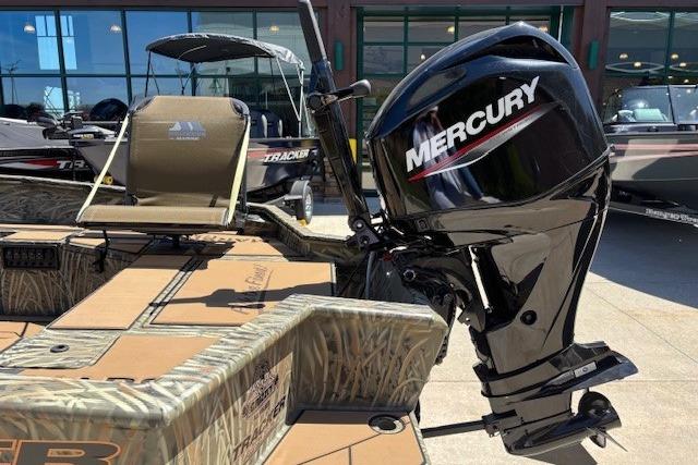 2026 Tracker Grizzly 1756 T Marsh boat with Mercury outboard motor, displayed outdoors.