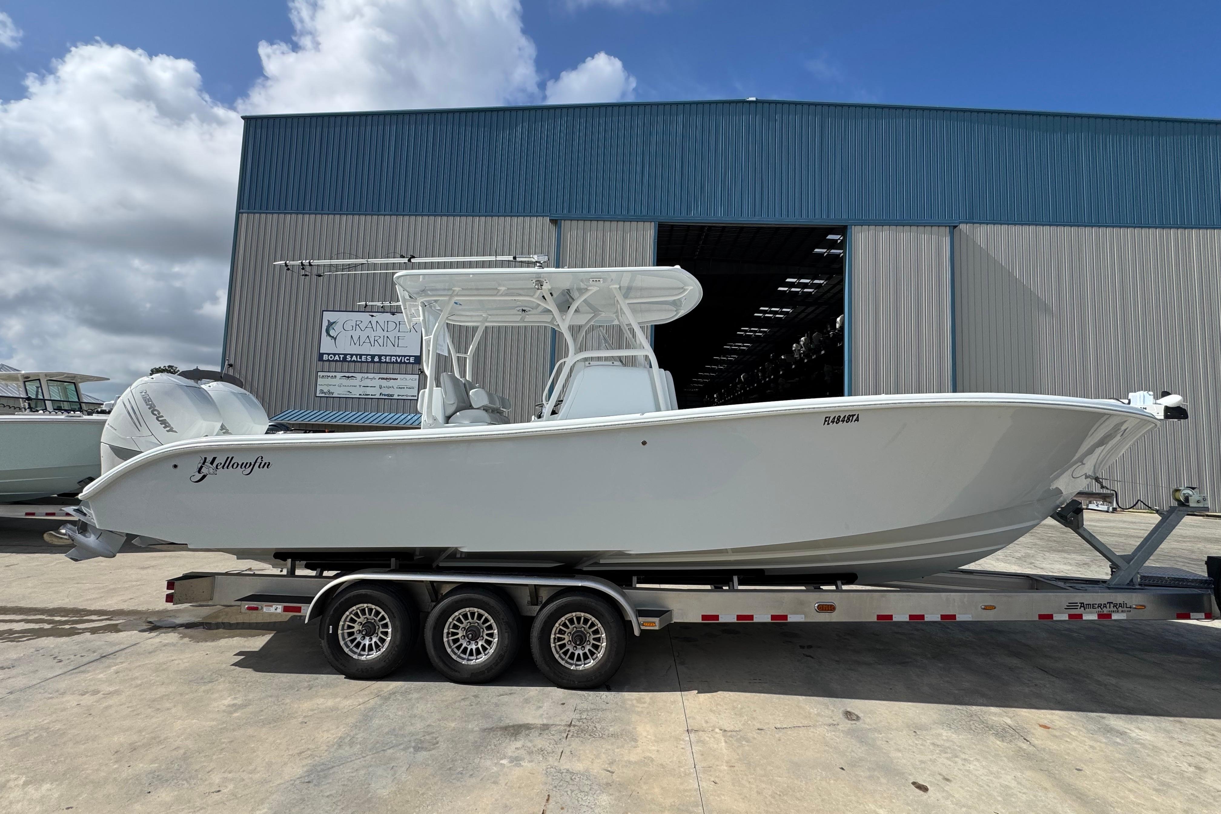 2022 Yellowfin 32 Offshore boat on trailer outside marine service building.