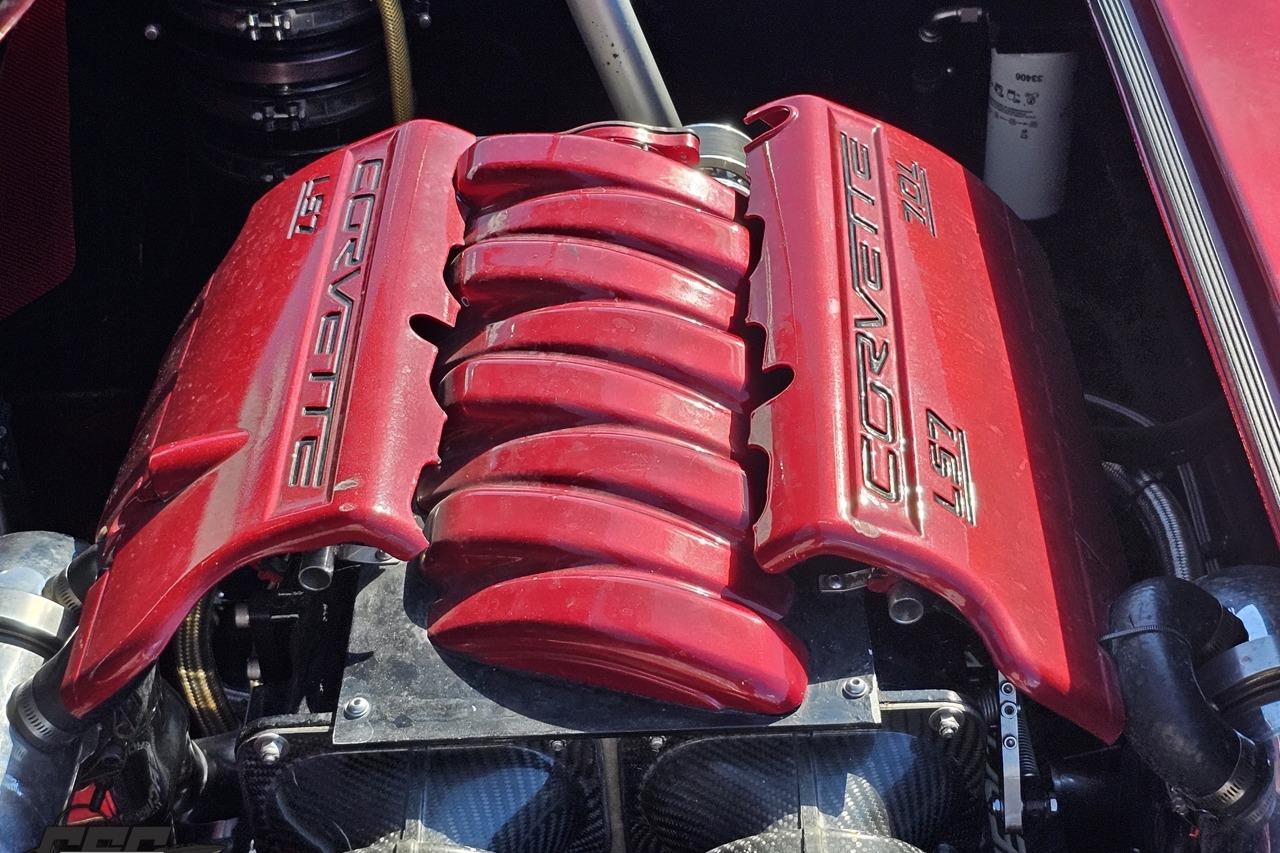 Red engine cover of a 2010 MTI 44 Corvette, showcasing Corvette L97 branding.