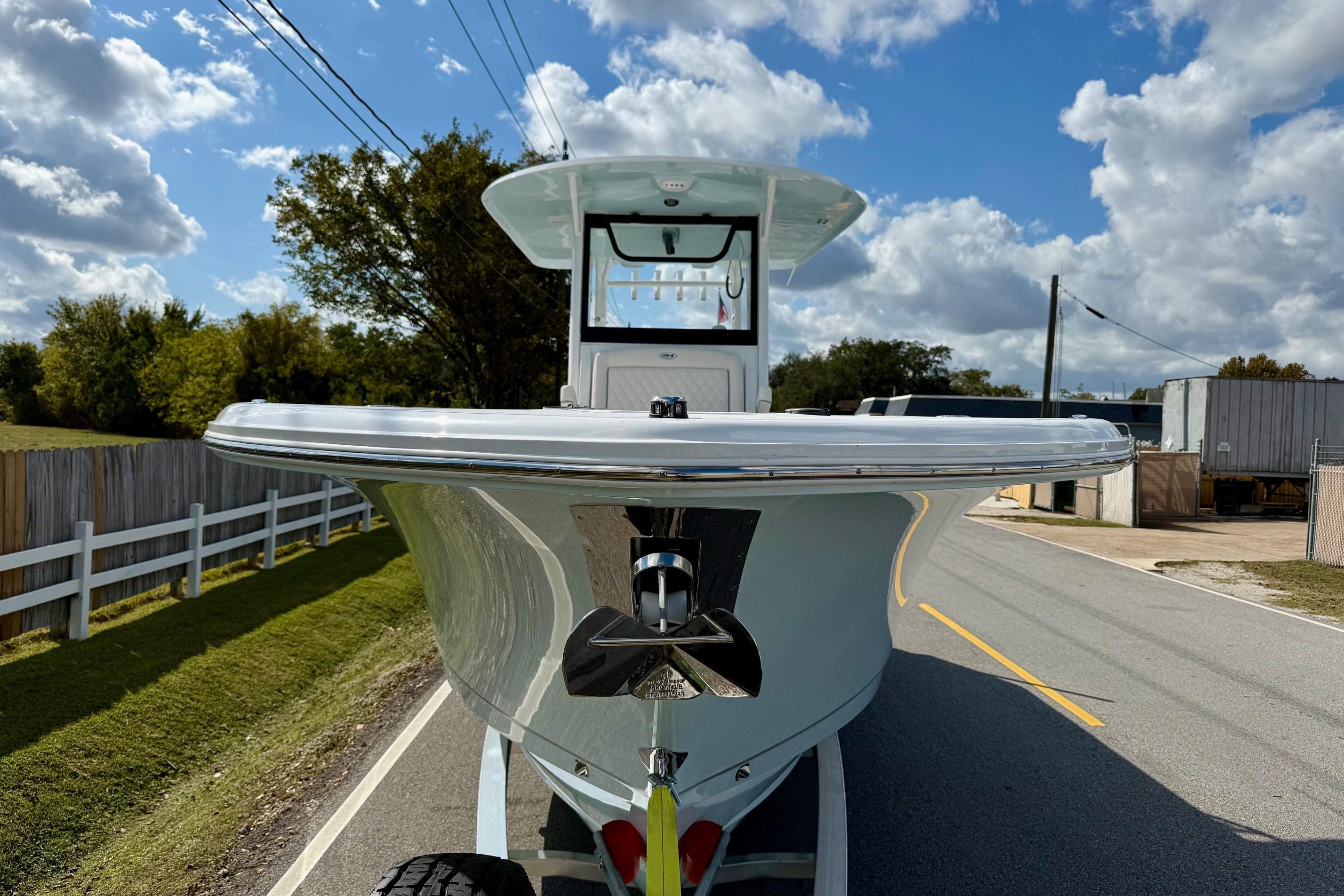 2026 Sea Hunt Ultra 285 Coffin Box boat on trailer, sunny day, road view.