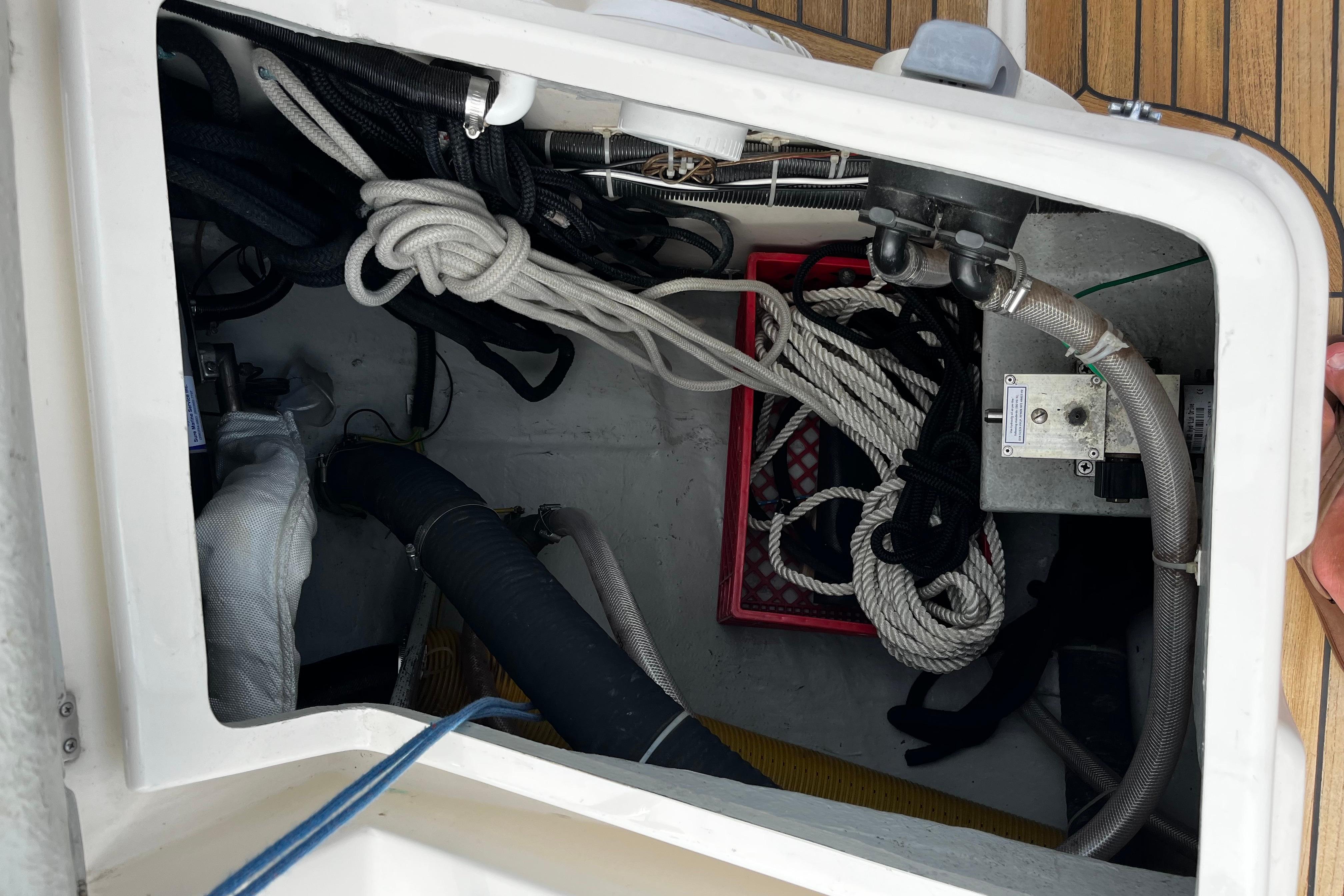 Storage compartment on a 2004 Hanse 411 sailboat with ropes and equipment.