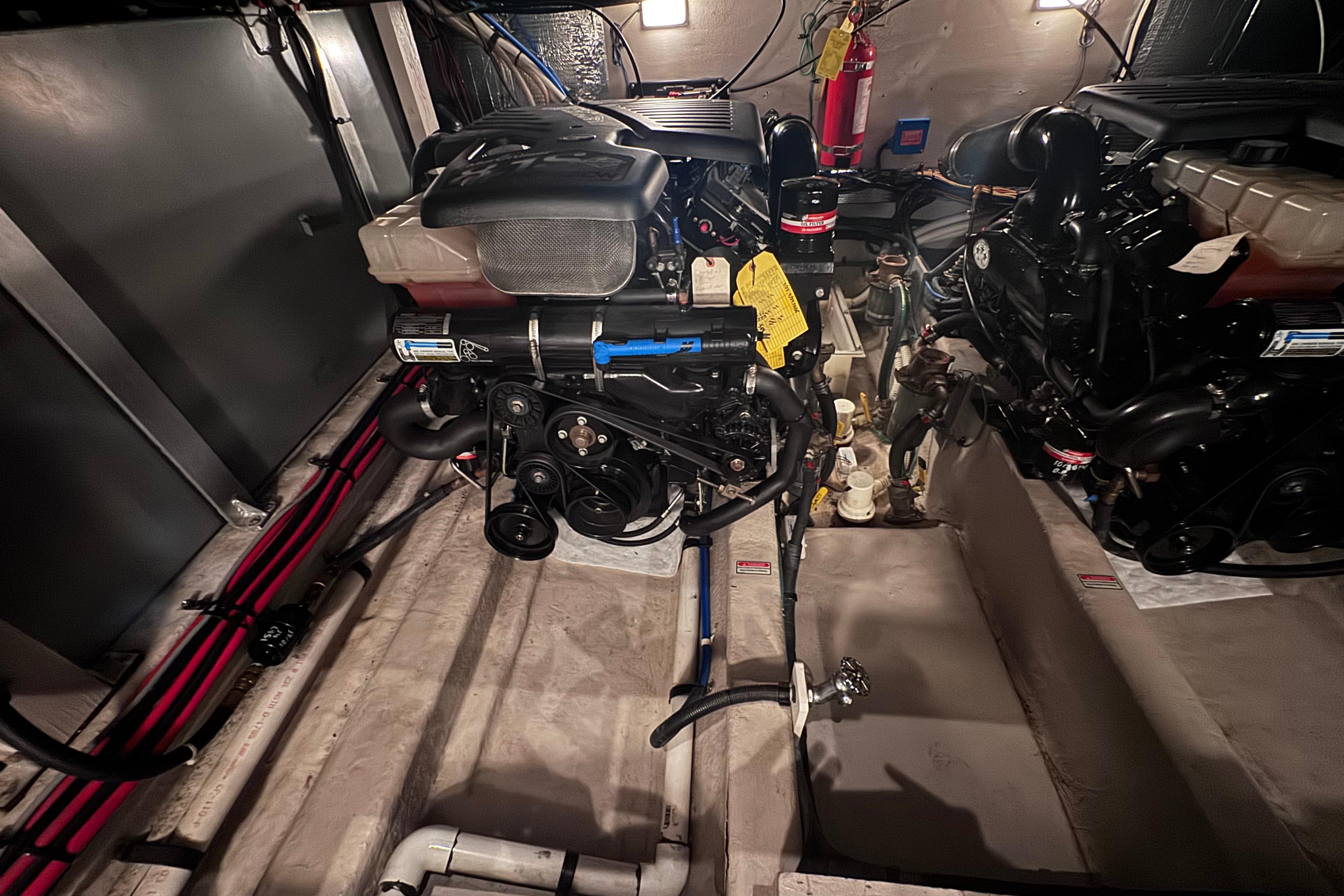Engine room of a 2004 Sea Ray 390 Motor Yacht, showcasing dual engines and equipment.