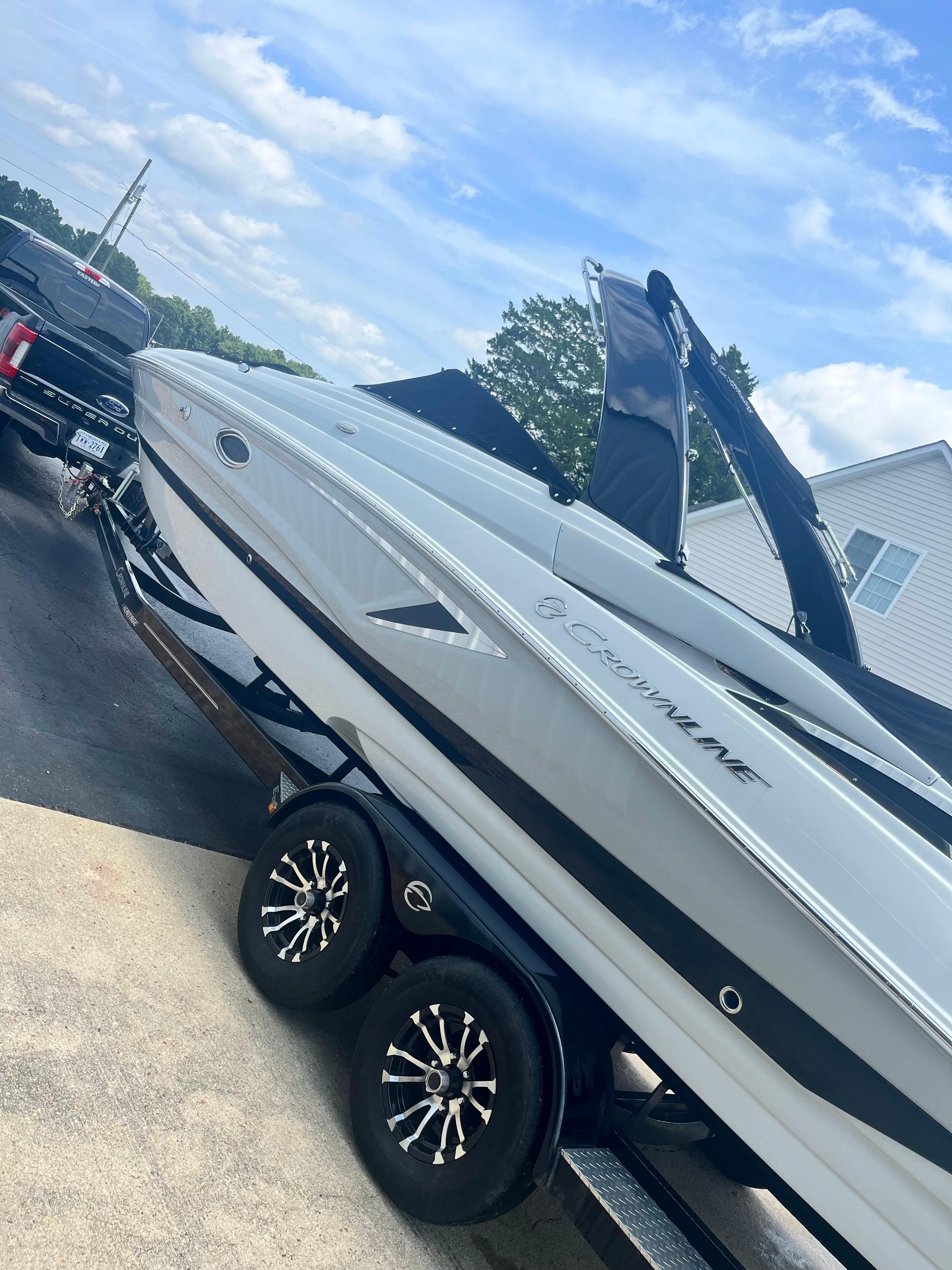 A 2019 Crownline E 285 boat on a trailer, ready for transport.