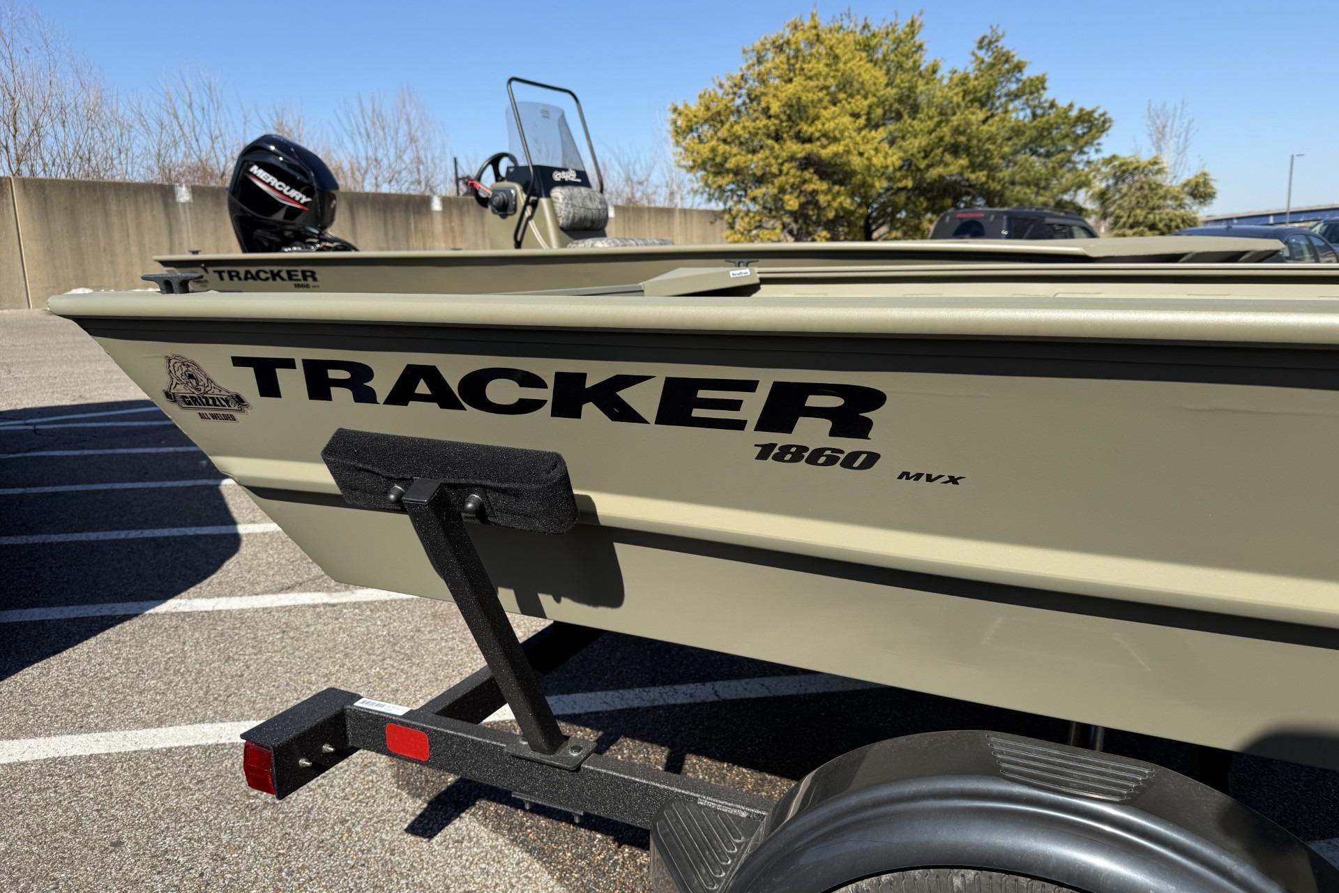 2026 Tracker Grizzly 1860 Utility boat on trailer, parked outdoors.