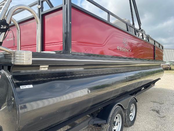 2023 Regency 250DL3 pontoon boat on trailer, featuring red and black design.