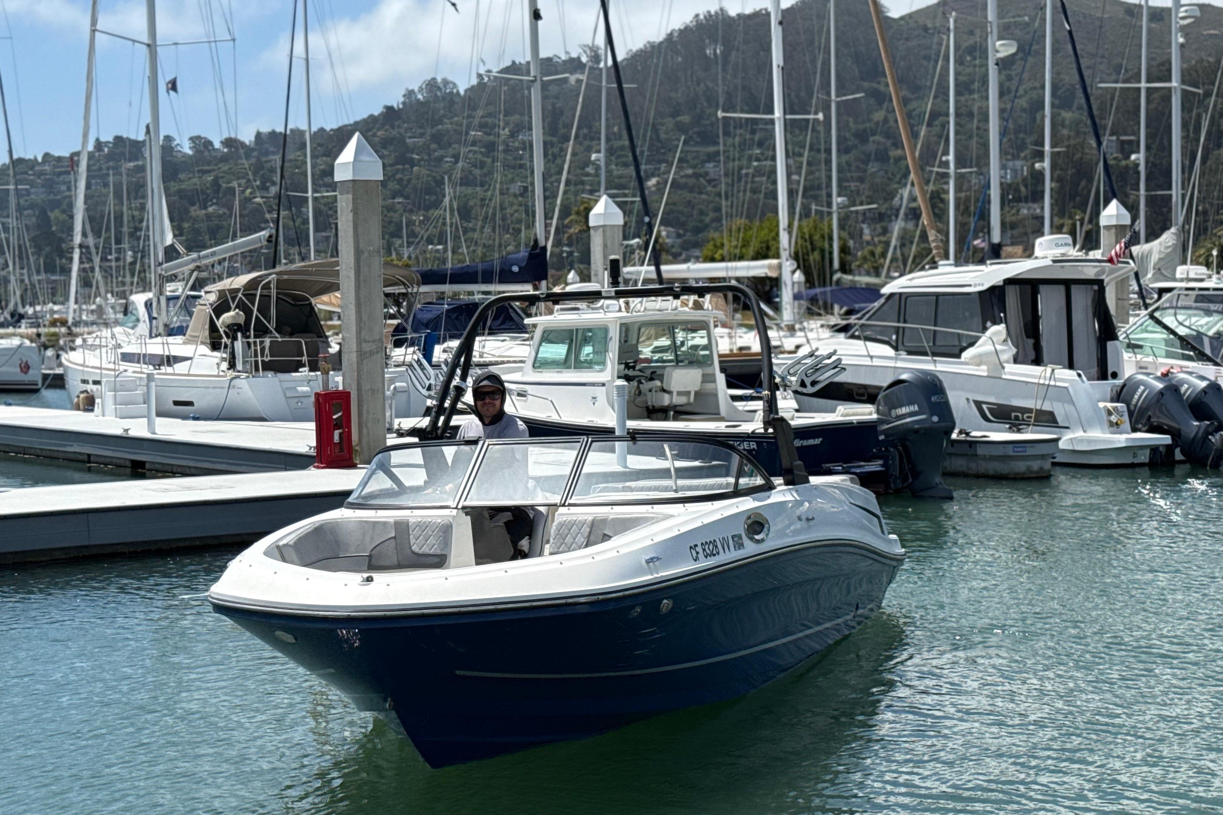 2021 Bayliner VR5 Bowrider I/O in marina, surrounded by sailboats and yachts.