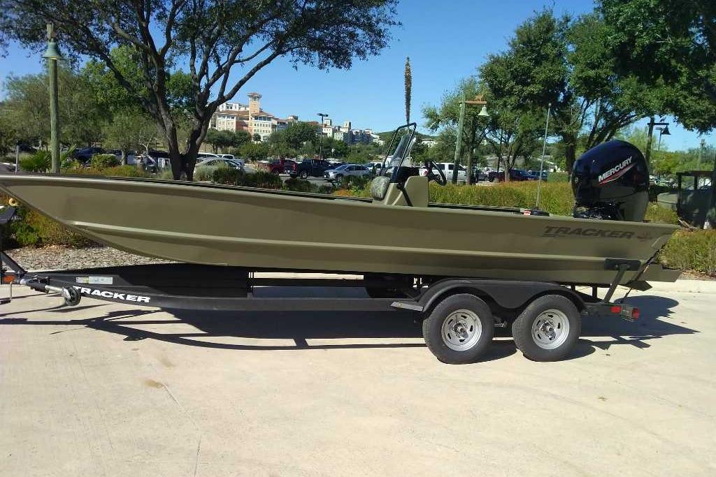 2026 Tracker Grizzly 2072 CC boat on trailer, parked outdoors.