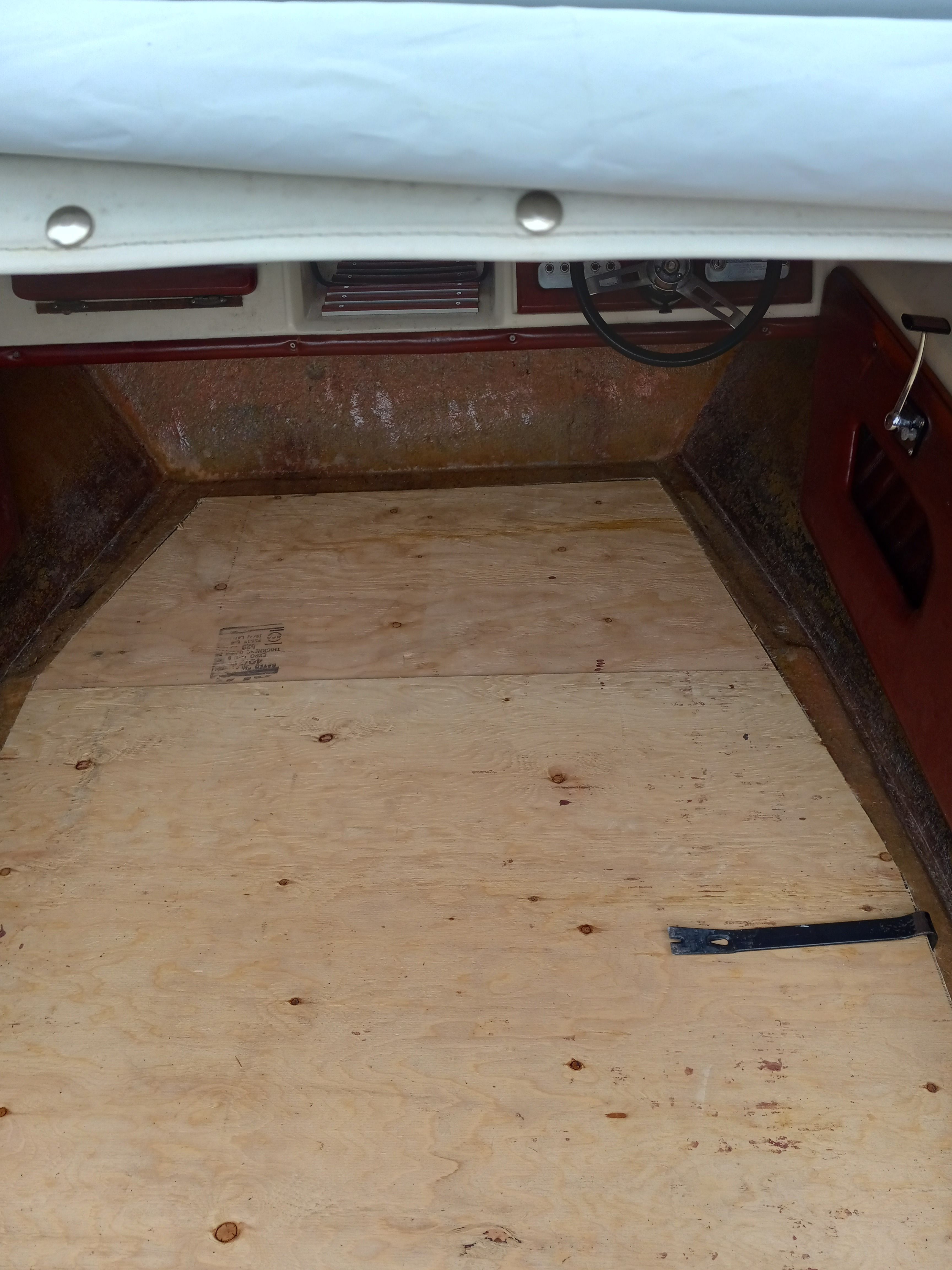 Interior of a 1977 Bayliner Jamaica boat with wooden flooring.