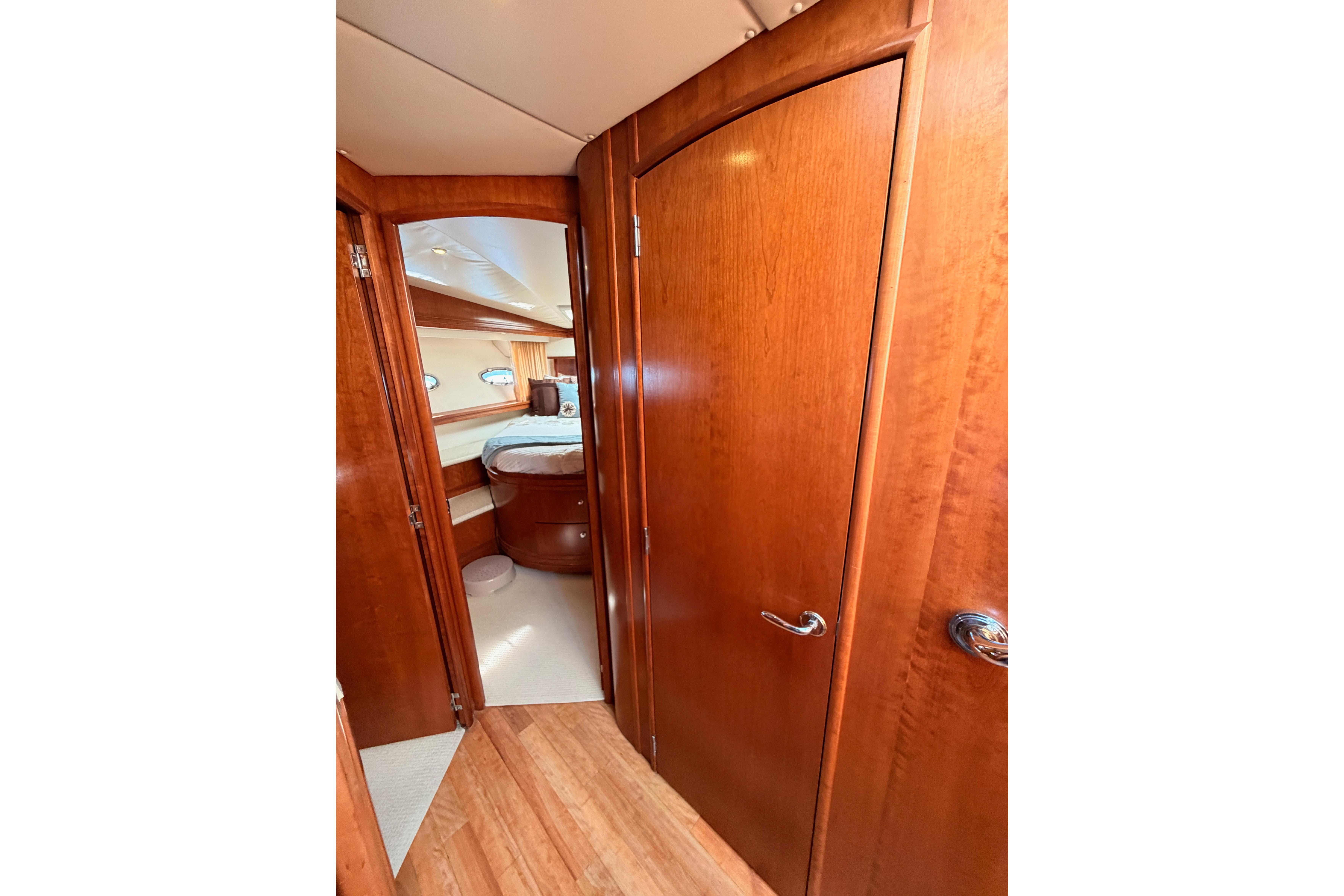 Interior of 1999 Carver 530 Voyager Pilothouse with wooden doors and cozy bedroom.