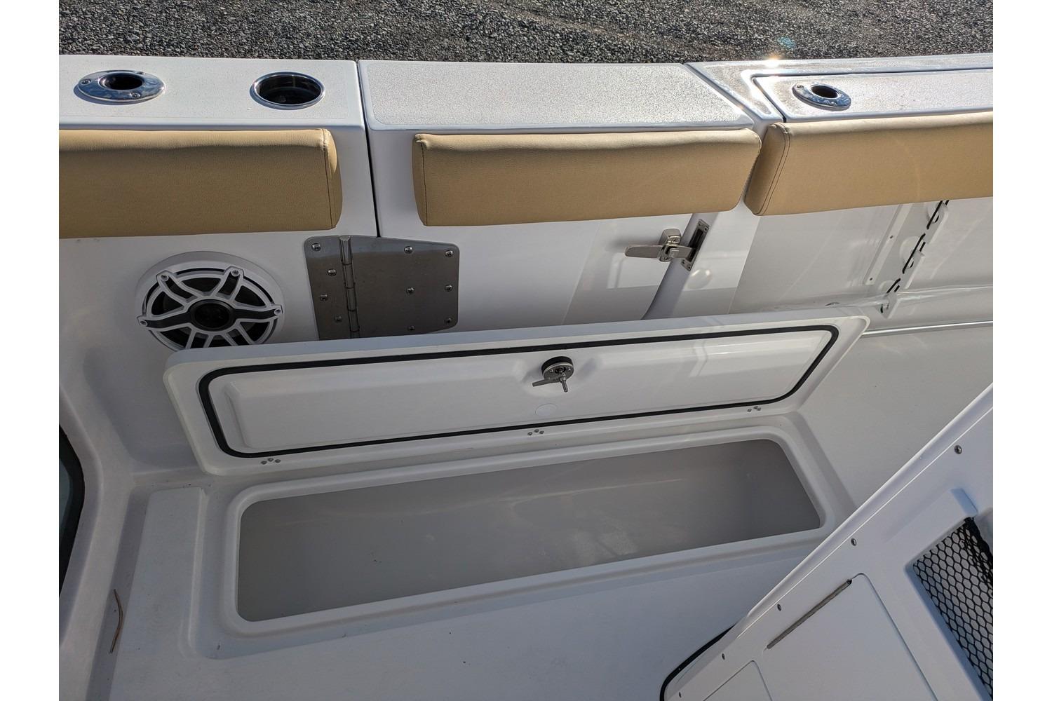 2025 Sportsman Open 282 Center Console boat interior with storage compartment and speaker.