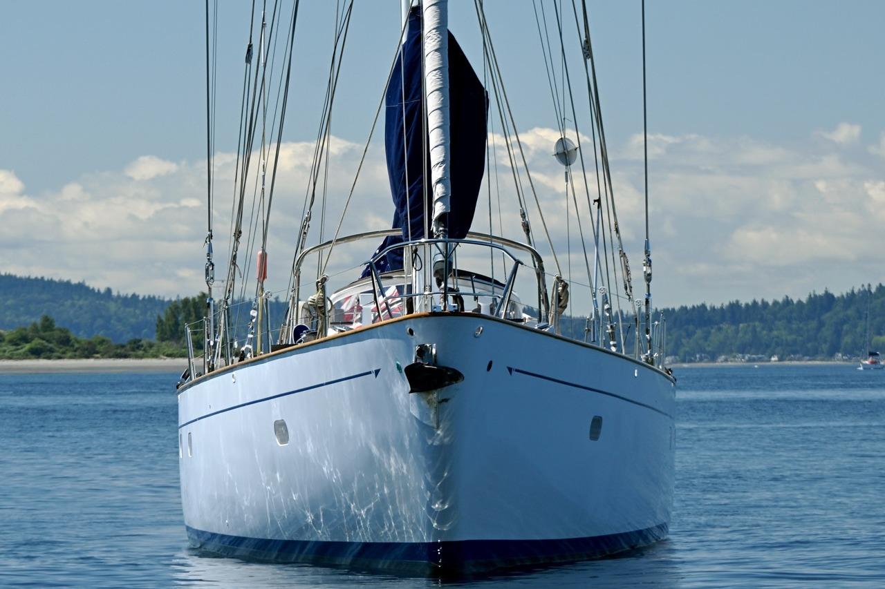 Front view of a 1968 Abeking & Rasmussen Tripp 74 yacht on calm waters.