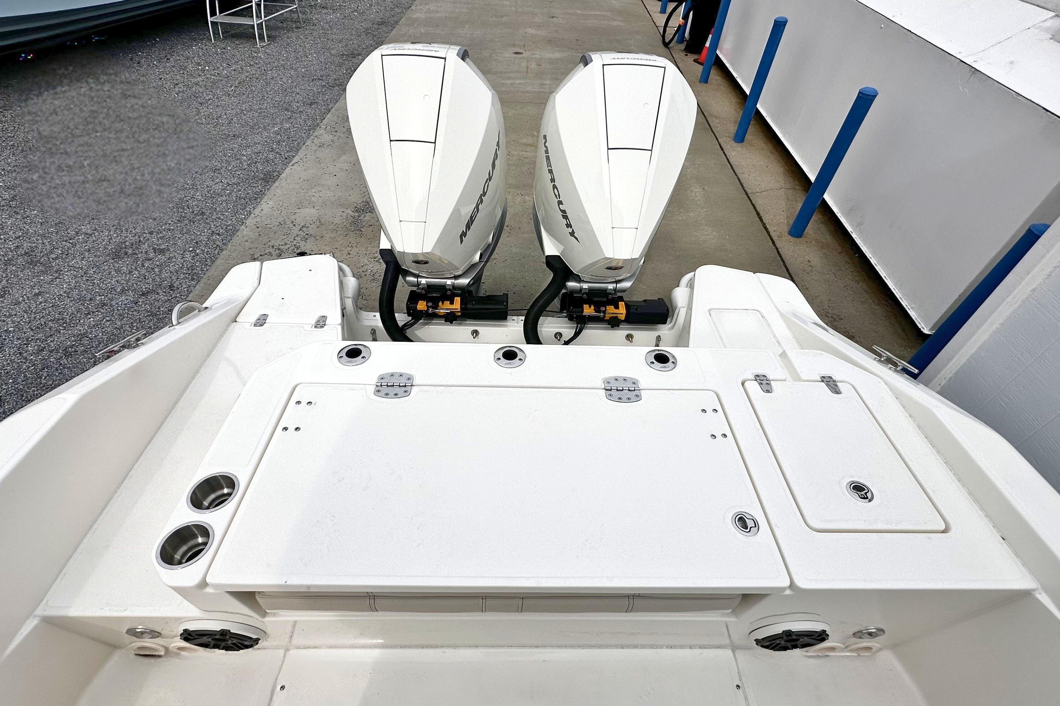 2026 Boston Whaler 280 Dauntless with dual Mercury outboard engines, rear deck view.