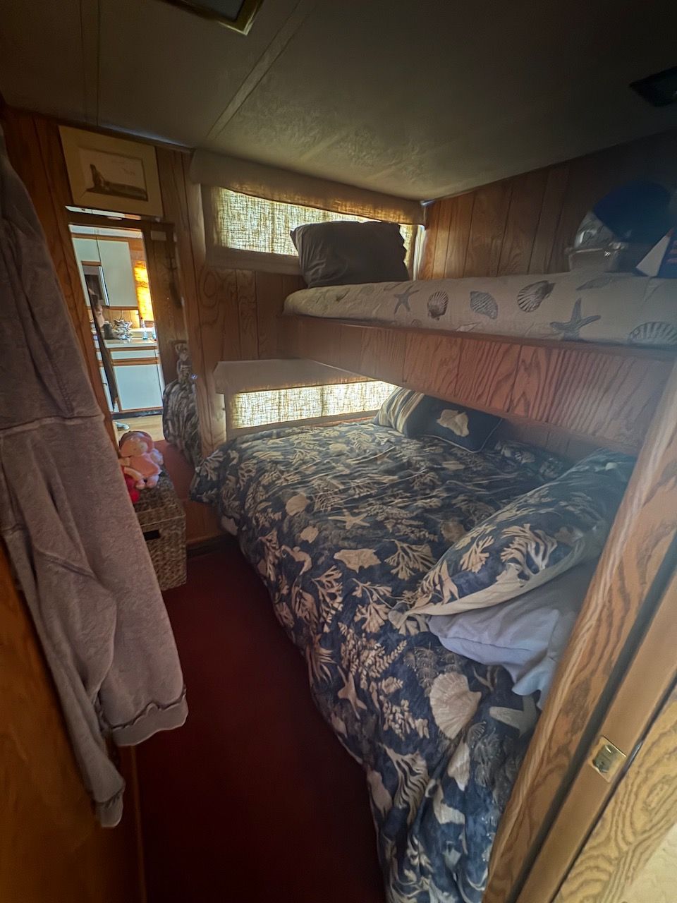 Interior of a Sumerset houseboat cabin with bunk beds and nautical decor.