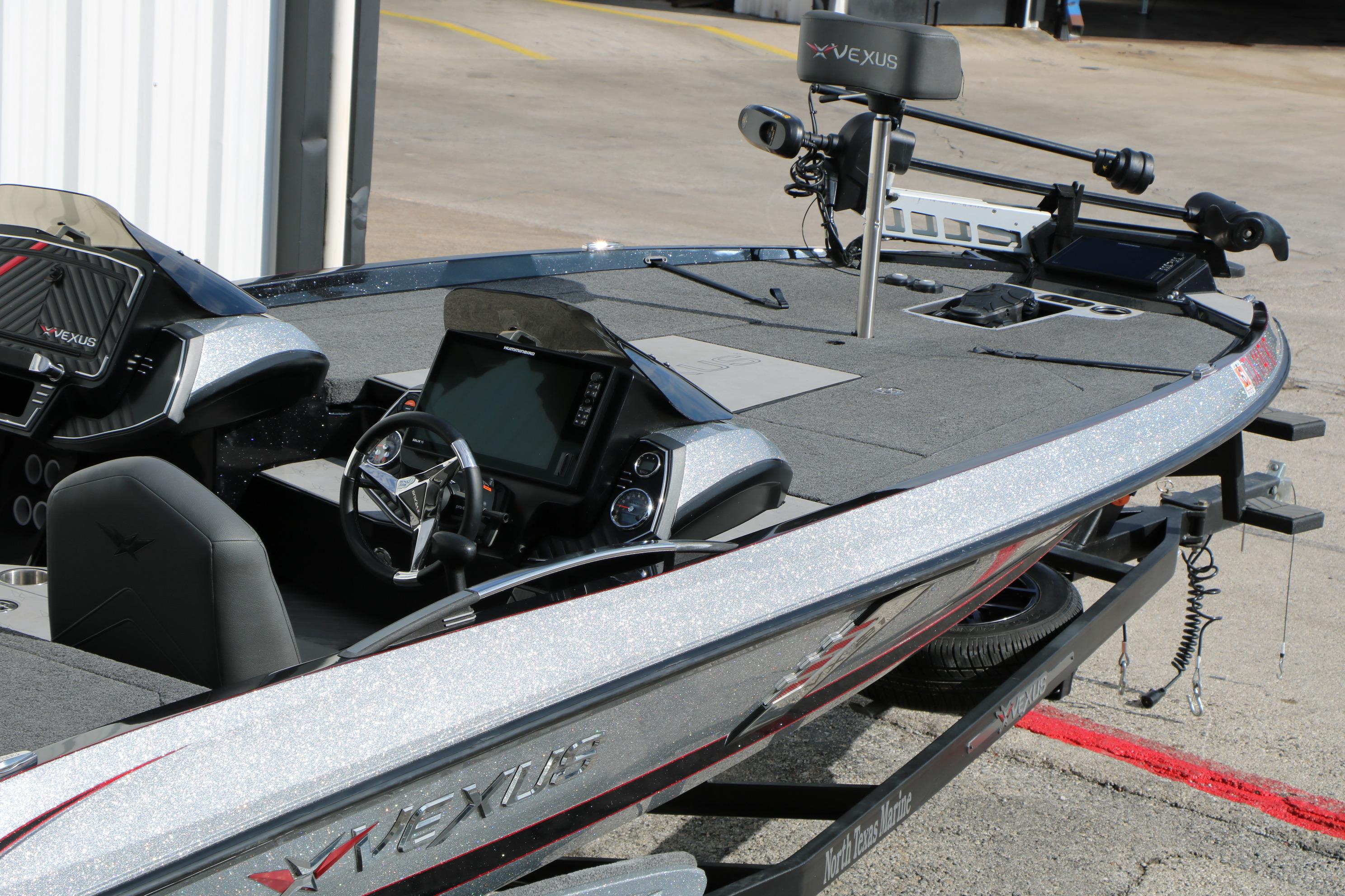 2022 Vexus VX21 boat with advanced dashboard and trolling motor, parked on a trailer.