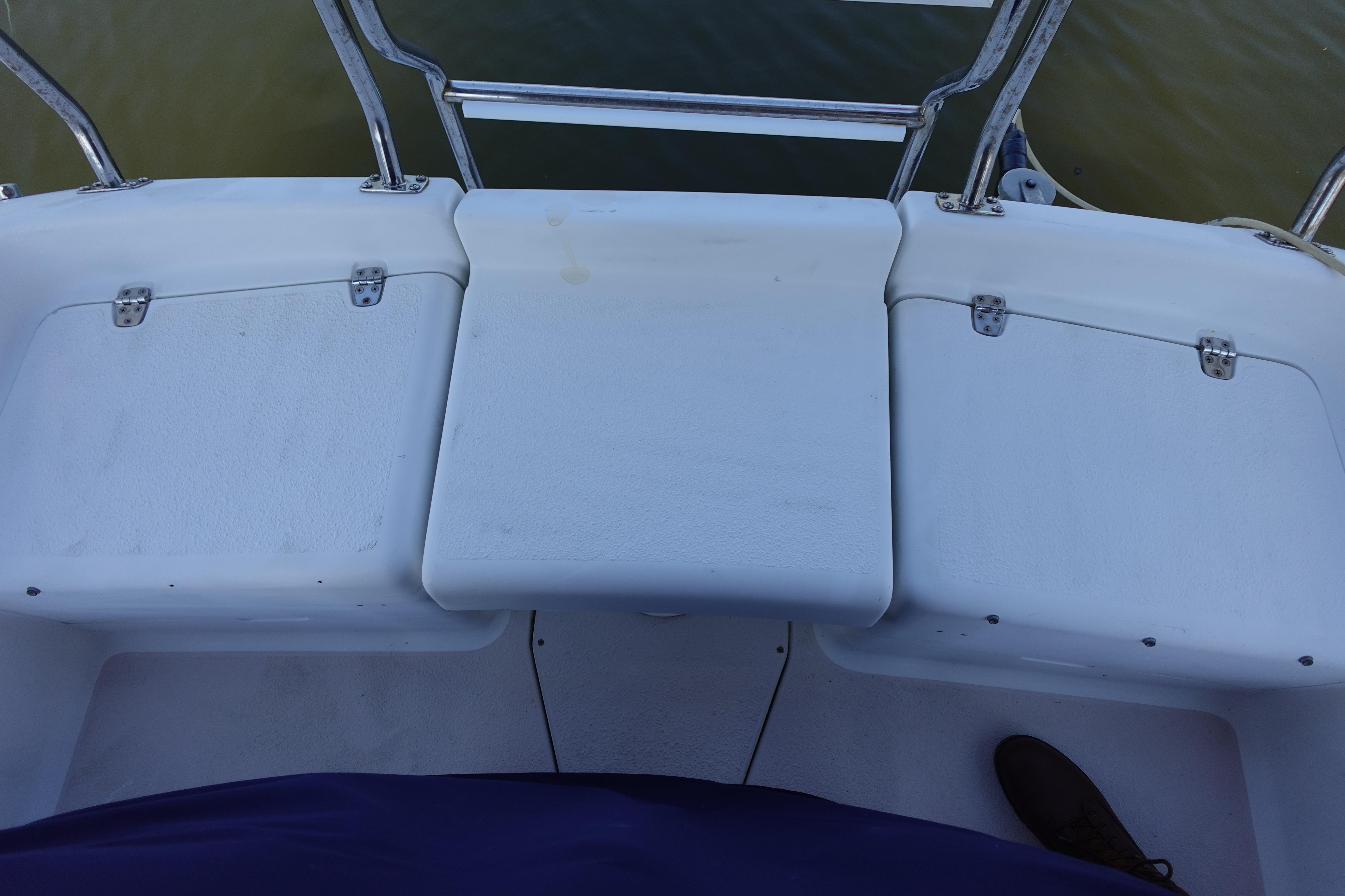 1997 Catalina 28 boat deck with white seating and metal railings.