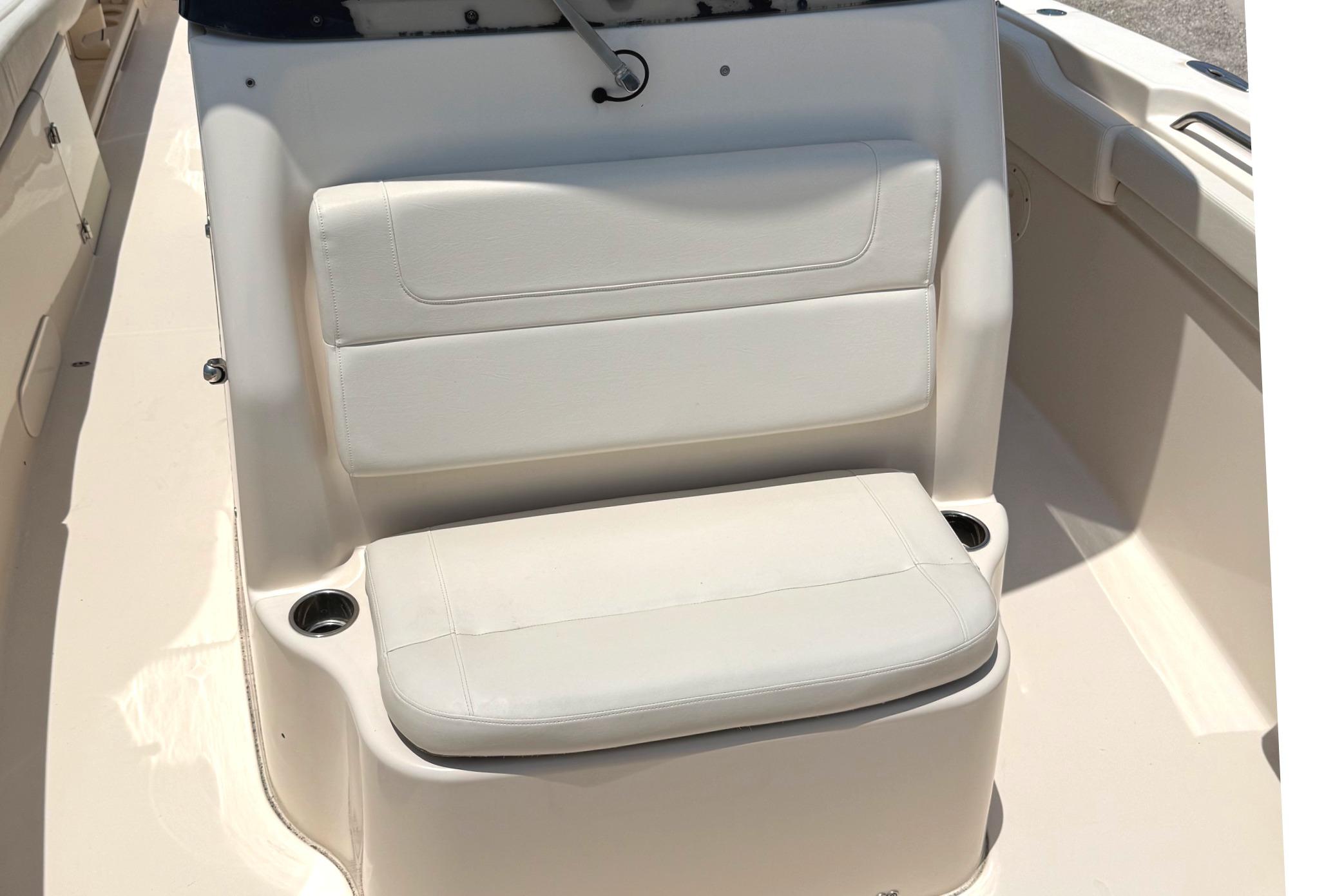 2018 Grady-White Canyon 306 boat seat with cup holders, beige upholstery.