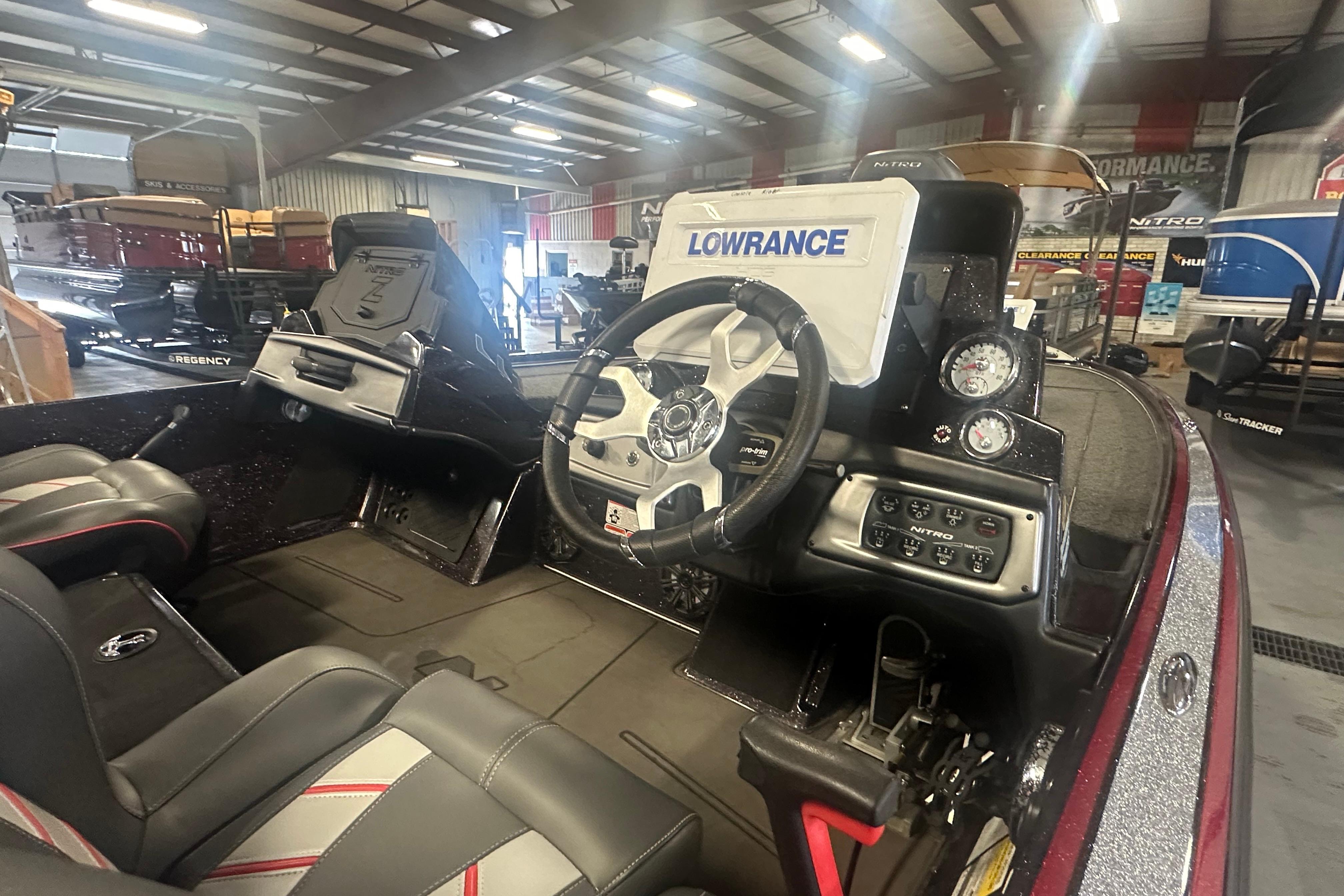 Interior of a 2022 Nitro Z20 Pro boat with steering wheel and Lowrance display.