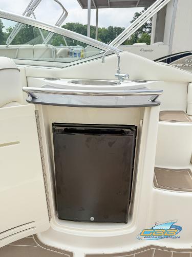 2008 Sea Ray 270 SLX boat interior with sink and mini fridge.