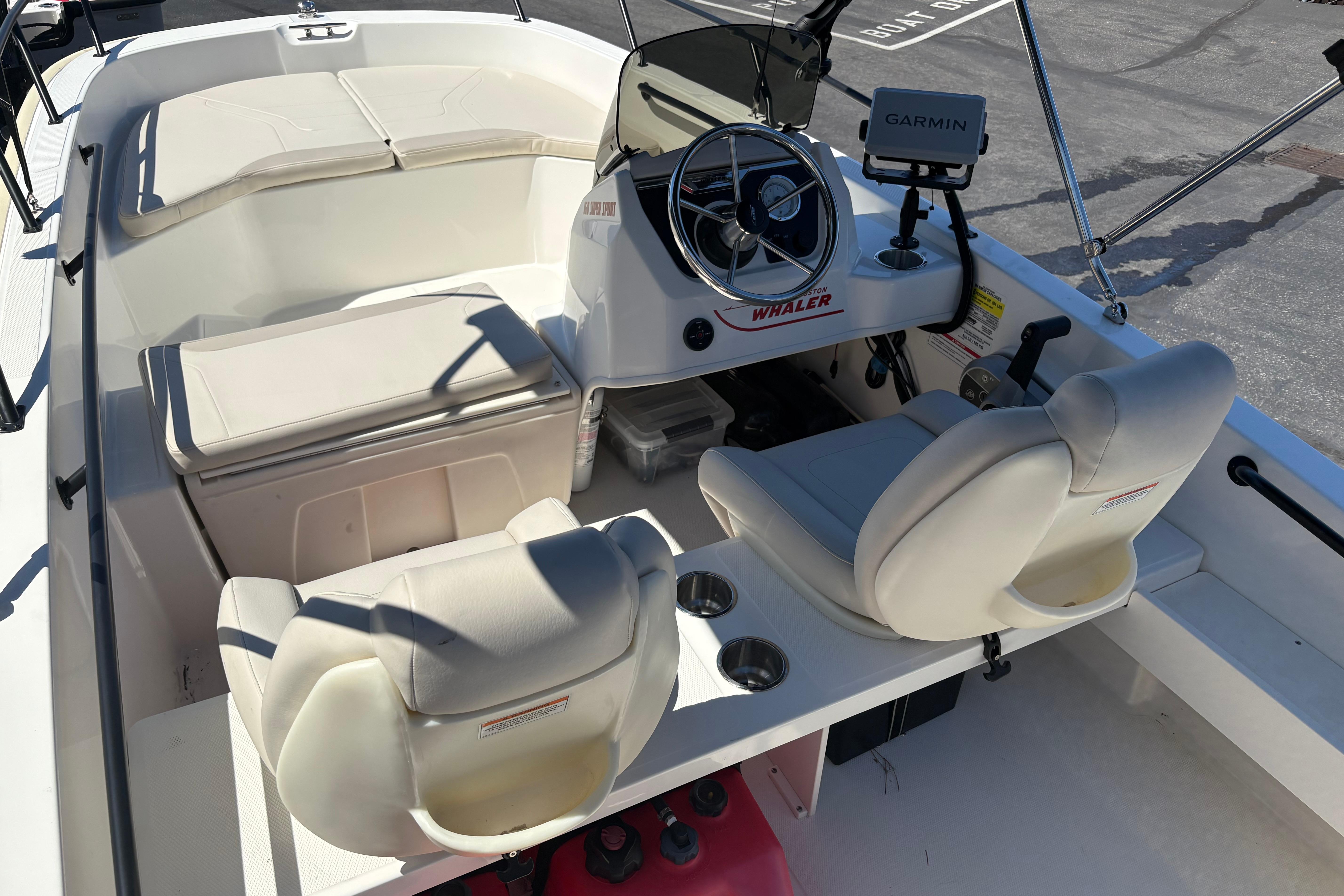 2024 Boston Whaler 160 Super Sport interior with steering wheel, seats, and Garmin navigation system.