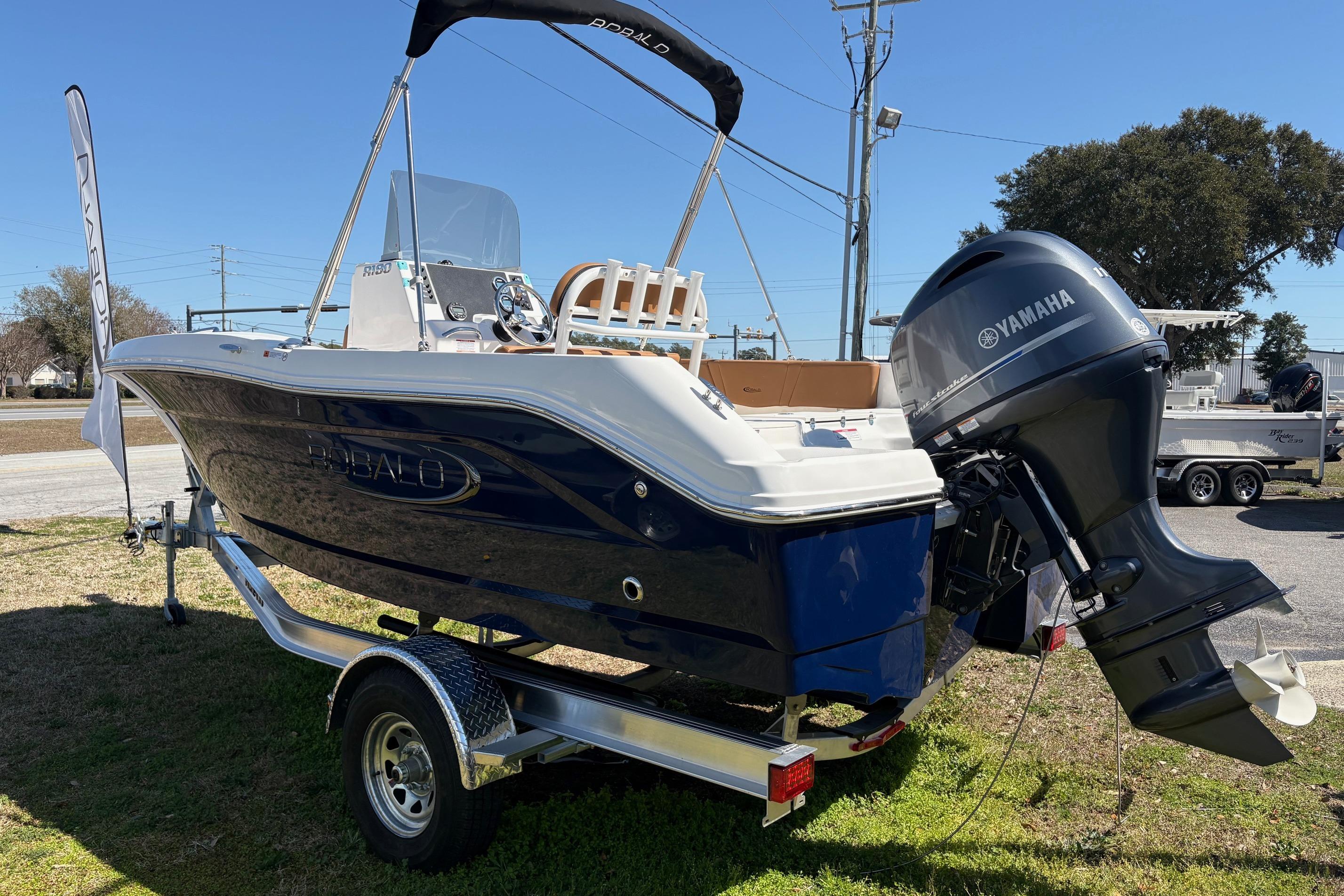 2026 Robalo R180 Center Console boat with Yamaha engine on trailer.