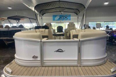 2026 SunCatcher Fusion 322SS pontoon boat displayed indoors with beige seating.