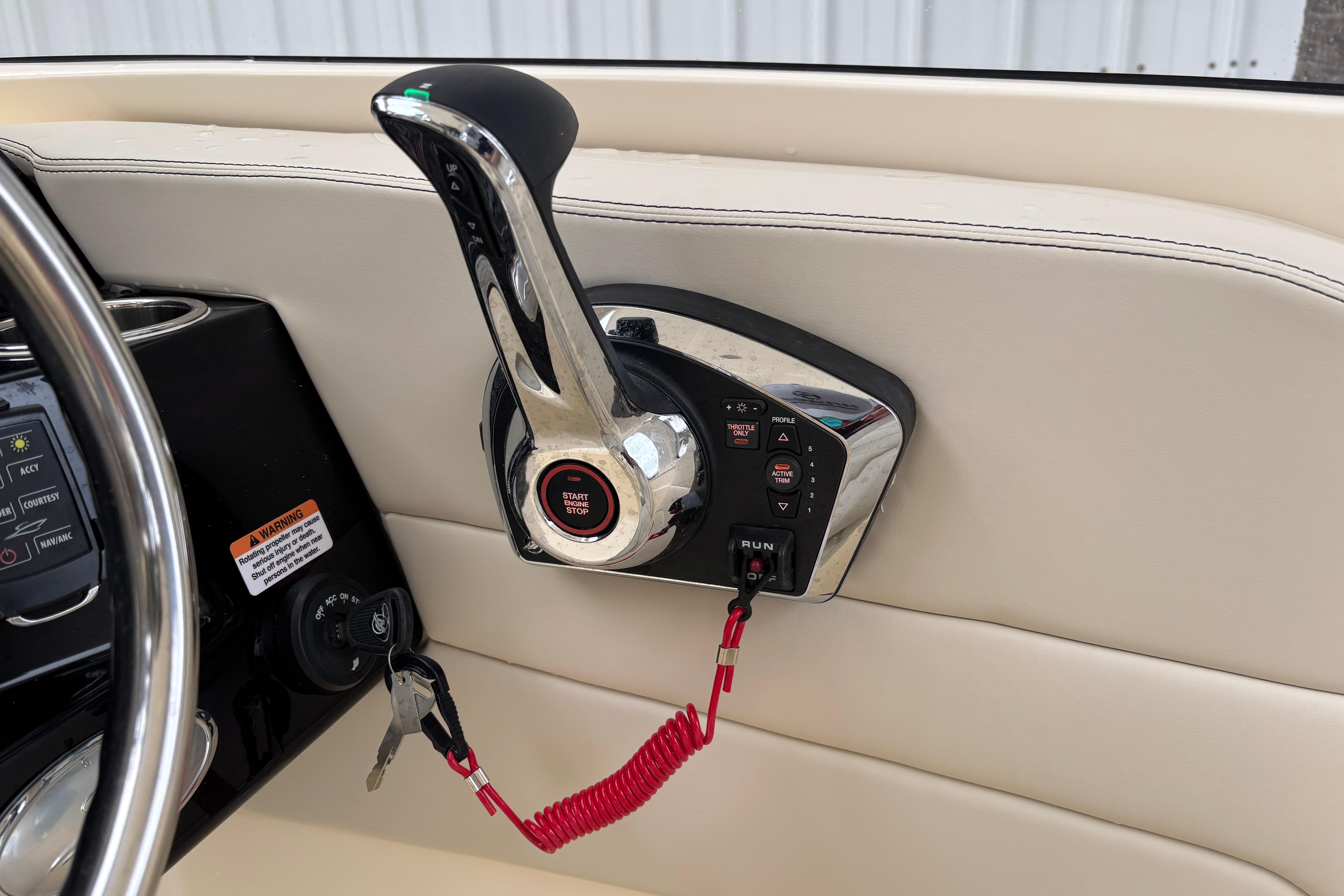 Control panel of 2026 Scout 240 Dorado boat with start-stop button and throttle lever.