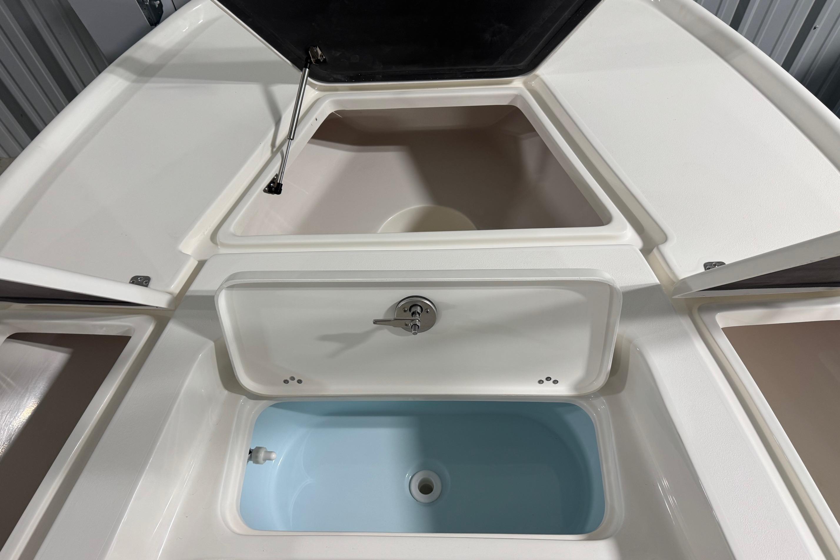 2026 Key West 210 Bay Reef boat storage compartments and livewell, showcasing interior design.