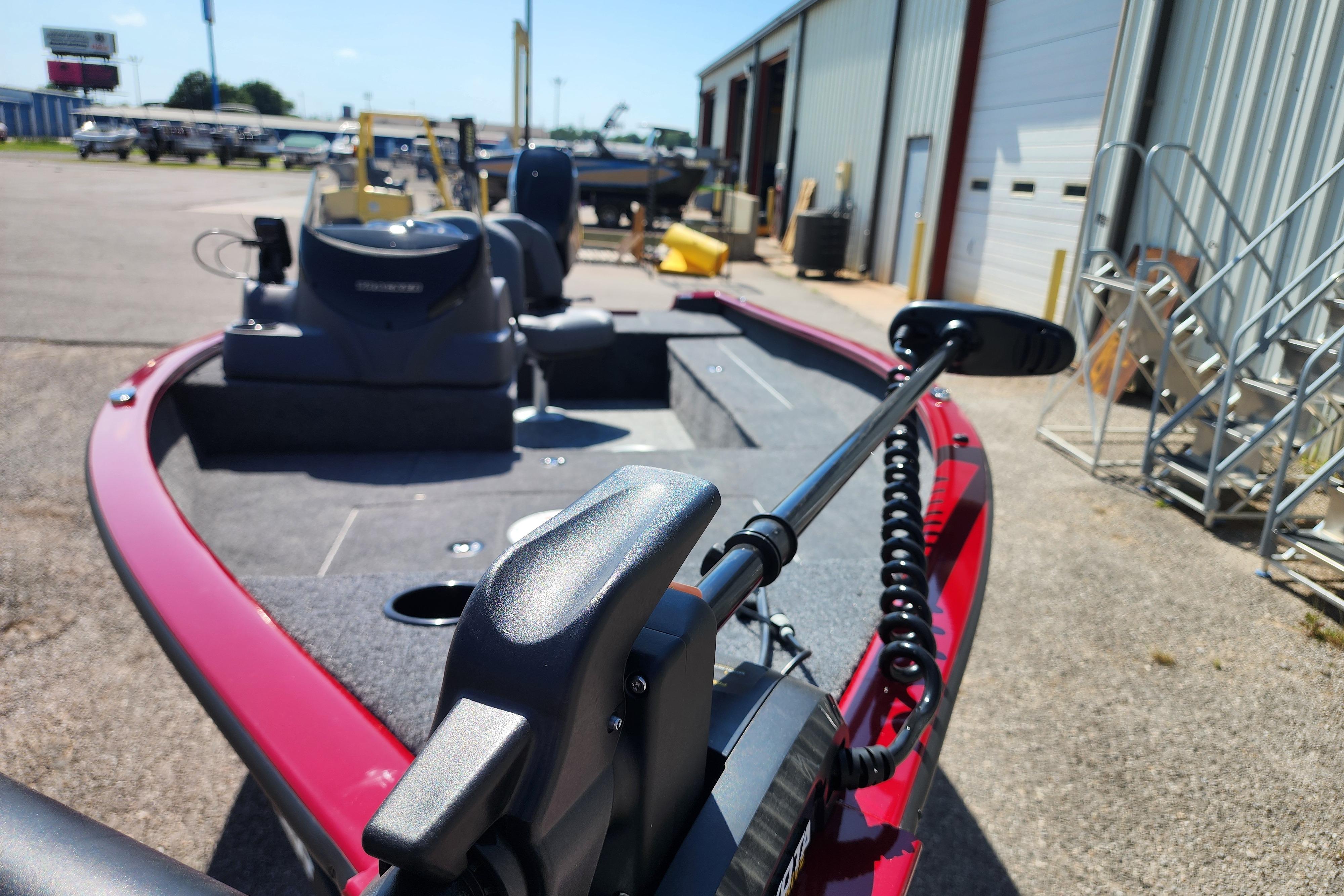 2026 Tracker Super Guide V-16 SC boat with trolling motor in a marina setting.
