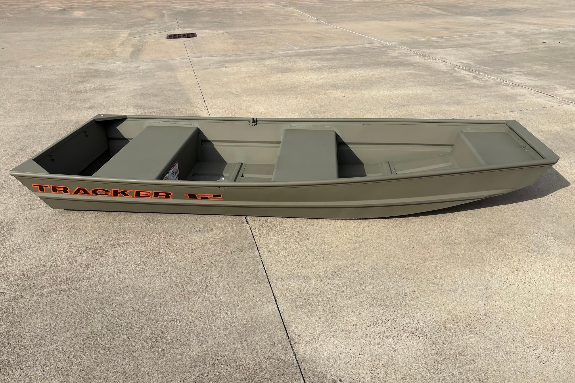 2026 Tracker Grizzly 12 Jon boat on concrete surface, showcasing its sturdy design.
