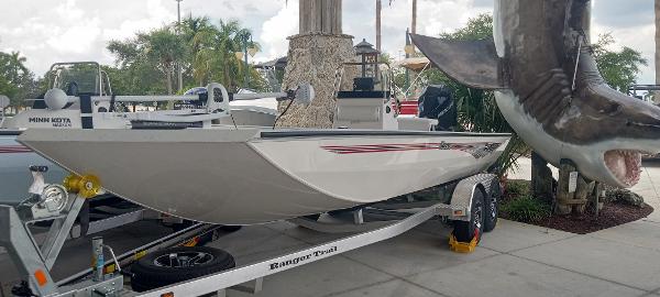 2024 Ranger RB210 boat on trailer beside large shark sculpture.