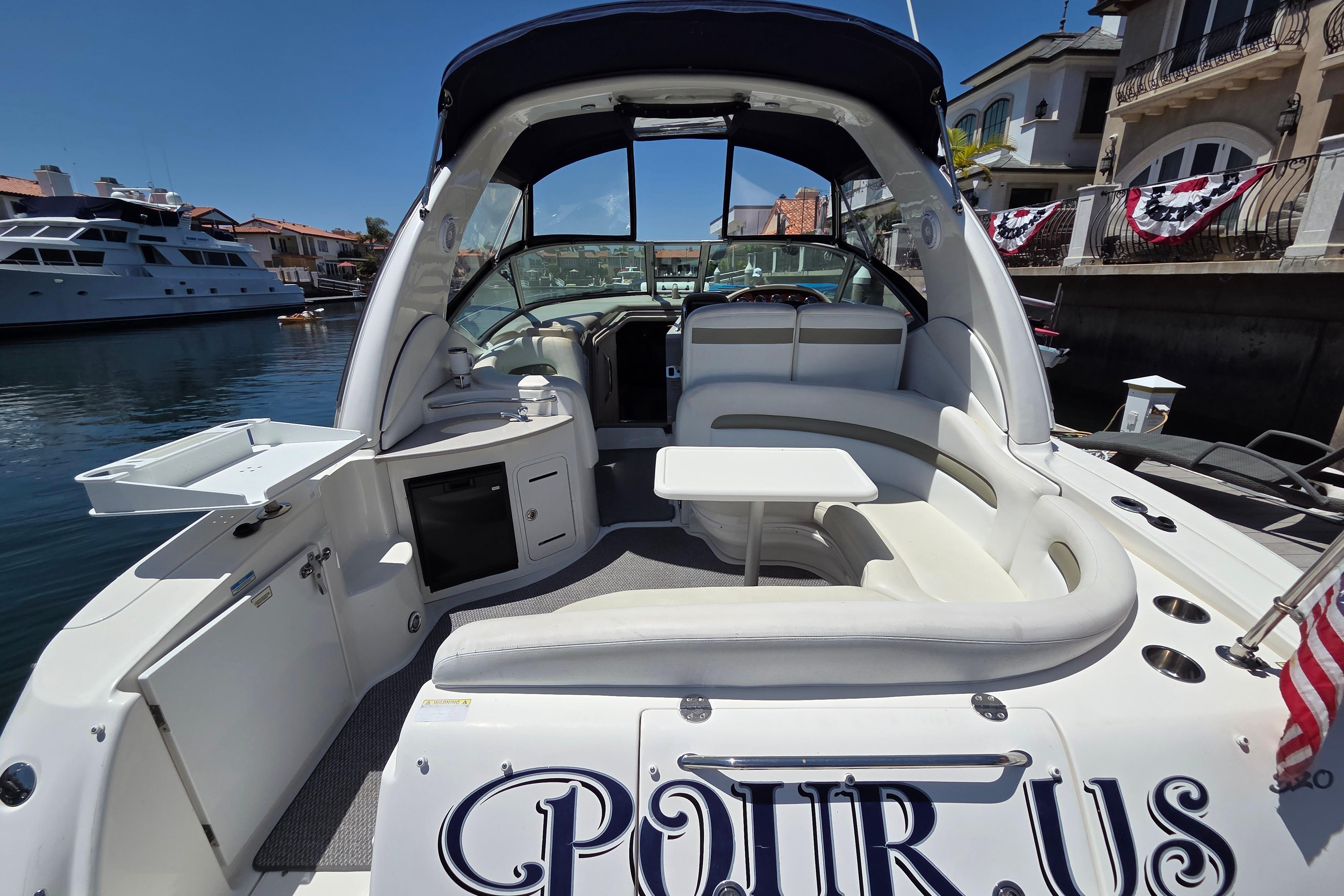 2006 Sea Ray Sundancer 320 yacht with spacious seating and elegant design docked in a marina.