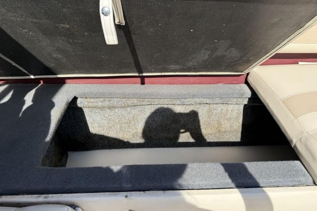 Open storage compartment in a 1999 Glastron GT 225 boat interior.