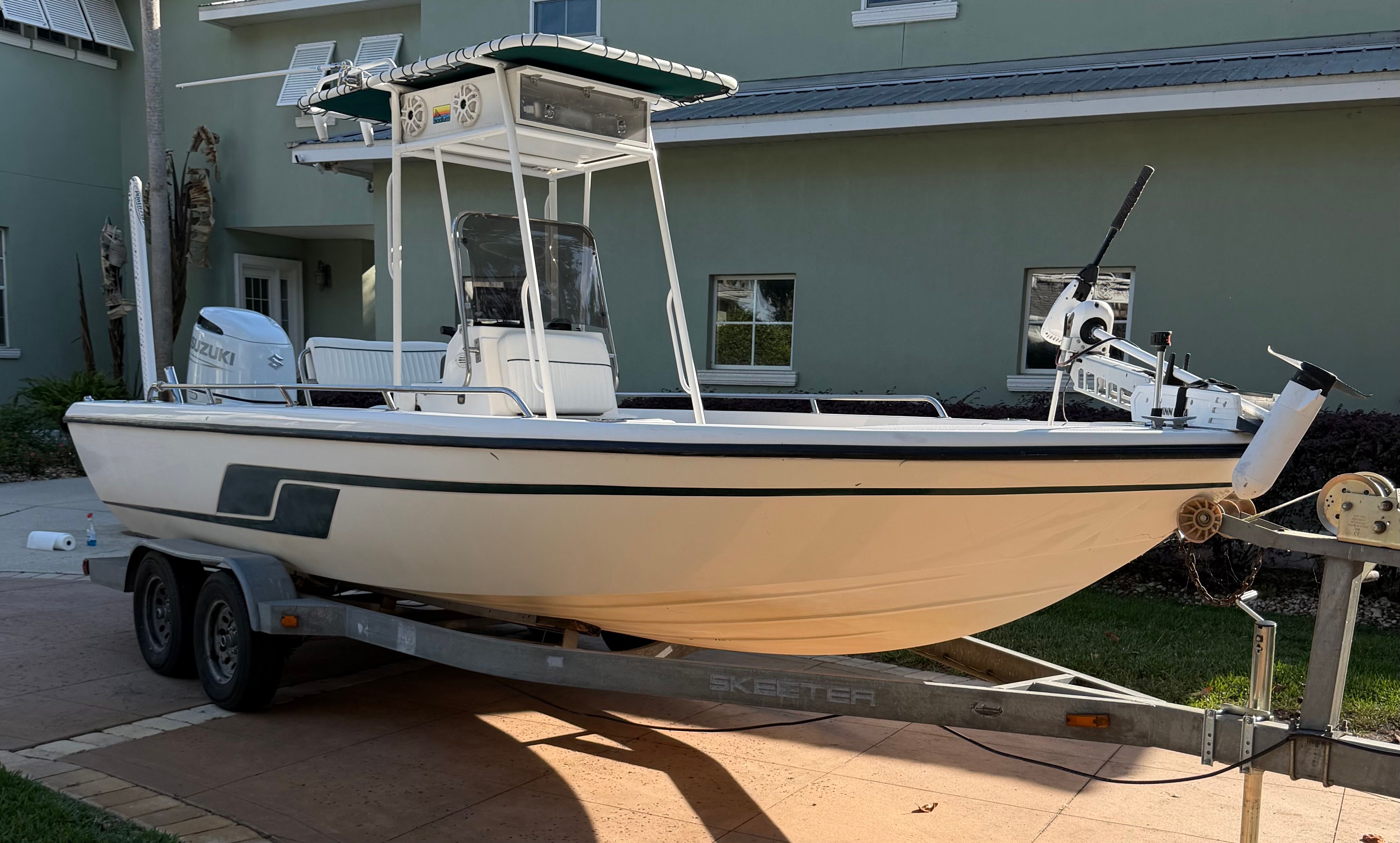 1999 Skeeter ZX2200 boat on trailer parked in front of house.