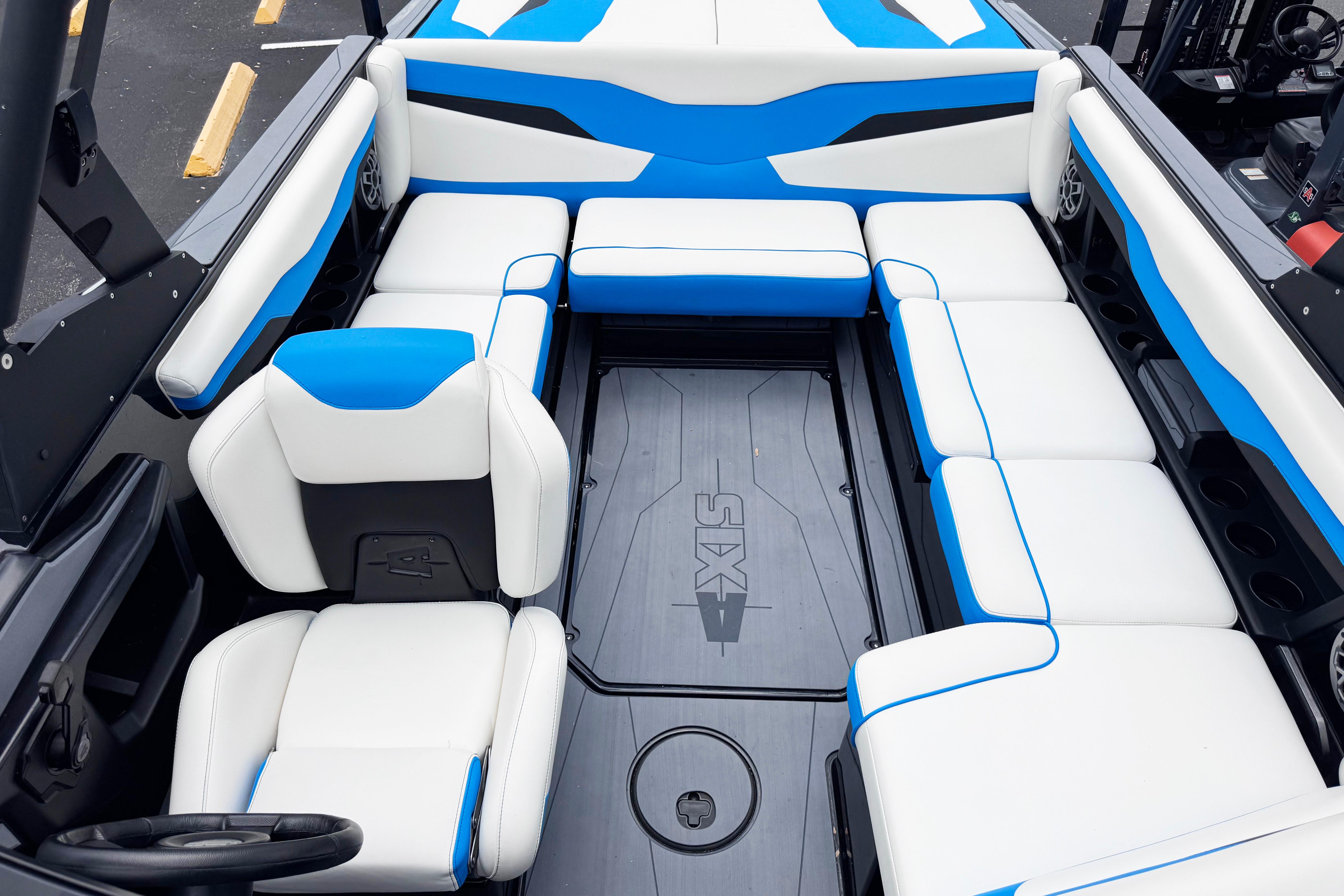 2022 Axis T220 boat interior with white and blue seating, showcasing spacious design.