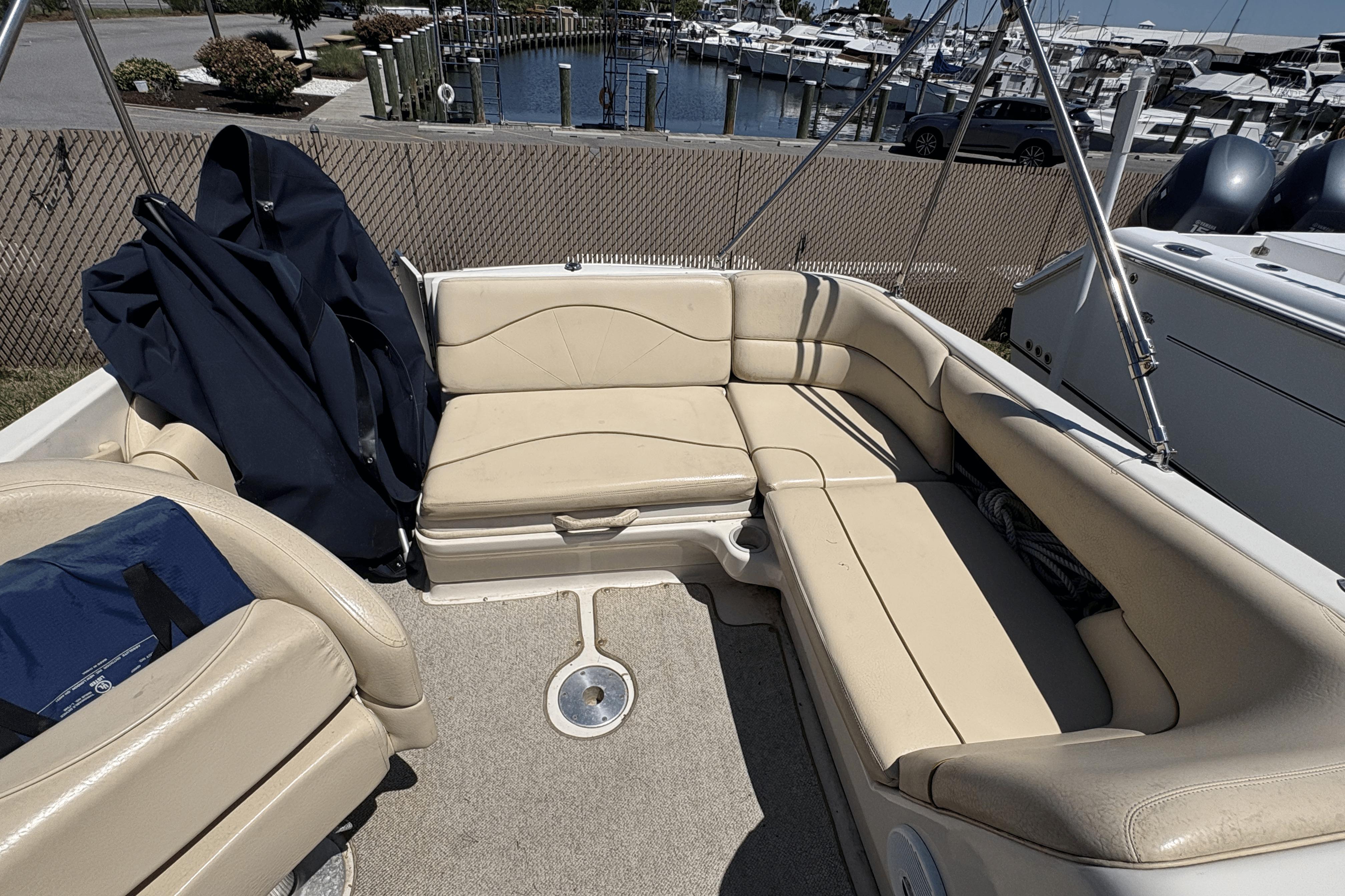 2001 Sea Ray 210 Sundeck interior with beige seating, docked at marina.