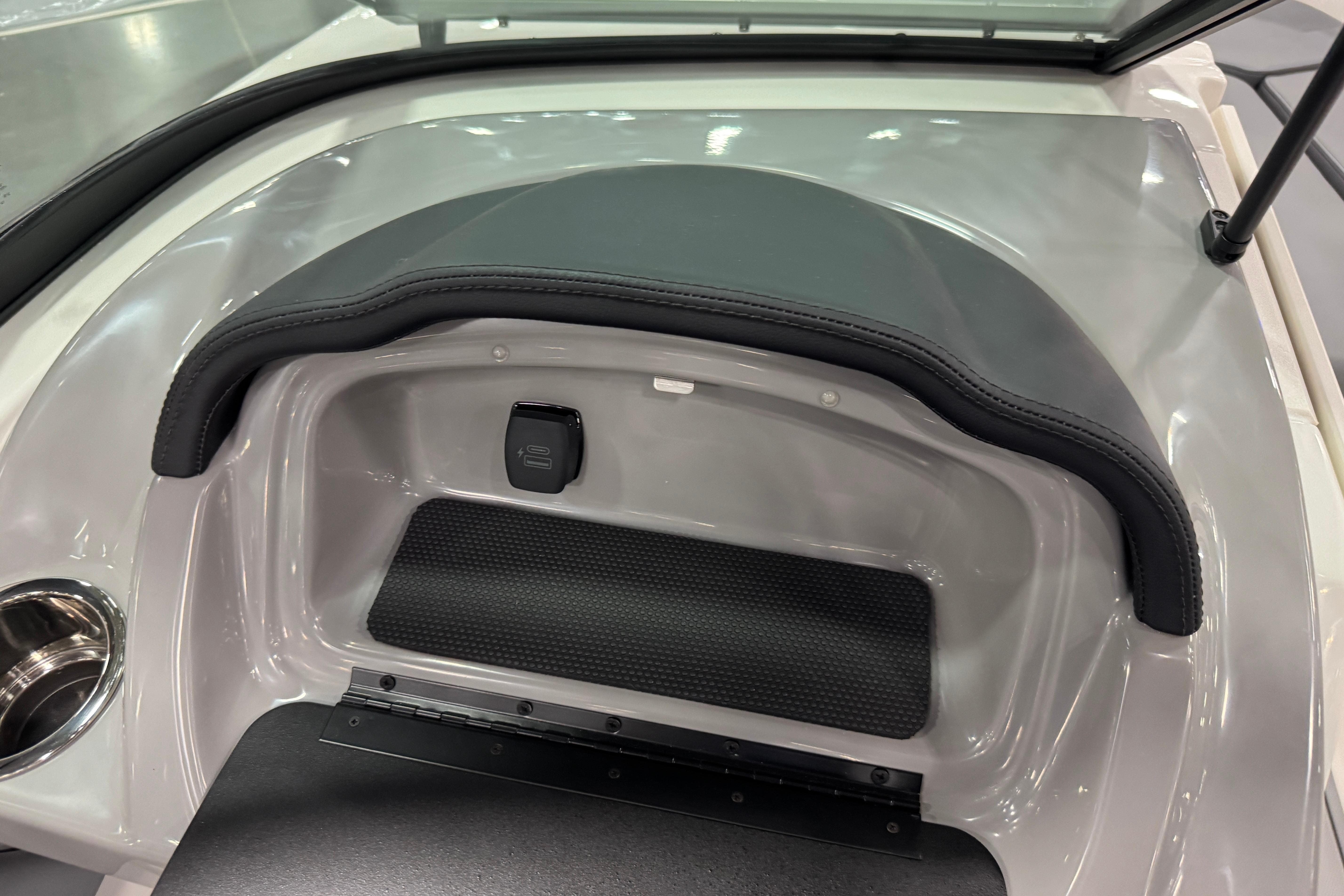 2026 Chaparral 23 SSi boat interior detail with cup holder and storage compartment.